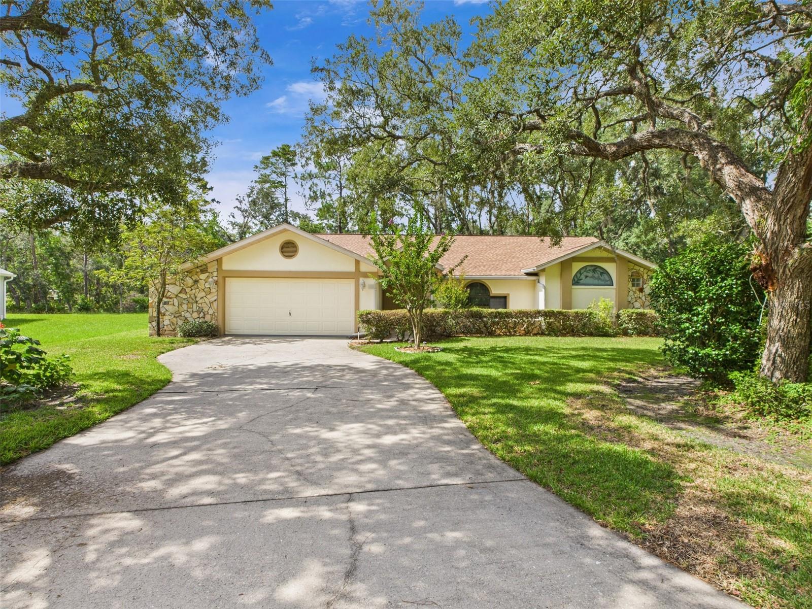 Discover this spacious 3/2.5/2 residence nestled on a cul-de-sac in the heart of Homosassa, perfect for transforming into your dream home. The versatile split floor plan offers comfort and privacy, featuring two separate living rooms, a dining area, and an inside laundry with a convenient half bath. The large bonus room provides flexible space ideal as a fourth bedroom, home office, or recreational area. Recent upgrades include a brand-new AC (2025) and a roof replacement in 2019, ensuring peace of mind for years to come. The exterior showcases mature landscaping and a lush greenbelt backyard, providing a serene backdrop ready to build the pool of your dreams. Located just minutes from public boat ramps heading to the scenic Homosassa River, you'll enjoy easy access to waterfront dining, shopping, and water-based adventures. Nature enthusiasts will appreciate nearby attractions including the Withlacoochee Forest, offering hiking, Jeep trail riding, and horseback riding. Plus, with the Suncoast Parkway close by, Tampa is within a short drive. Sugarmill Woods amenities include a golf course, tennis courts, community pool, and a clubhouse, offering a vibrant social scene. Don’t miss the opportunity to make this inviting home yours schedule a tour today!