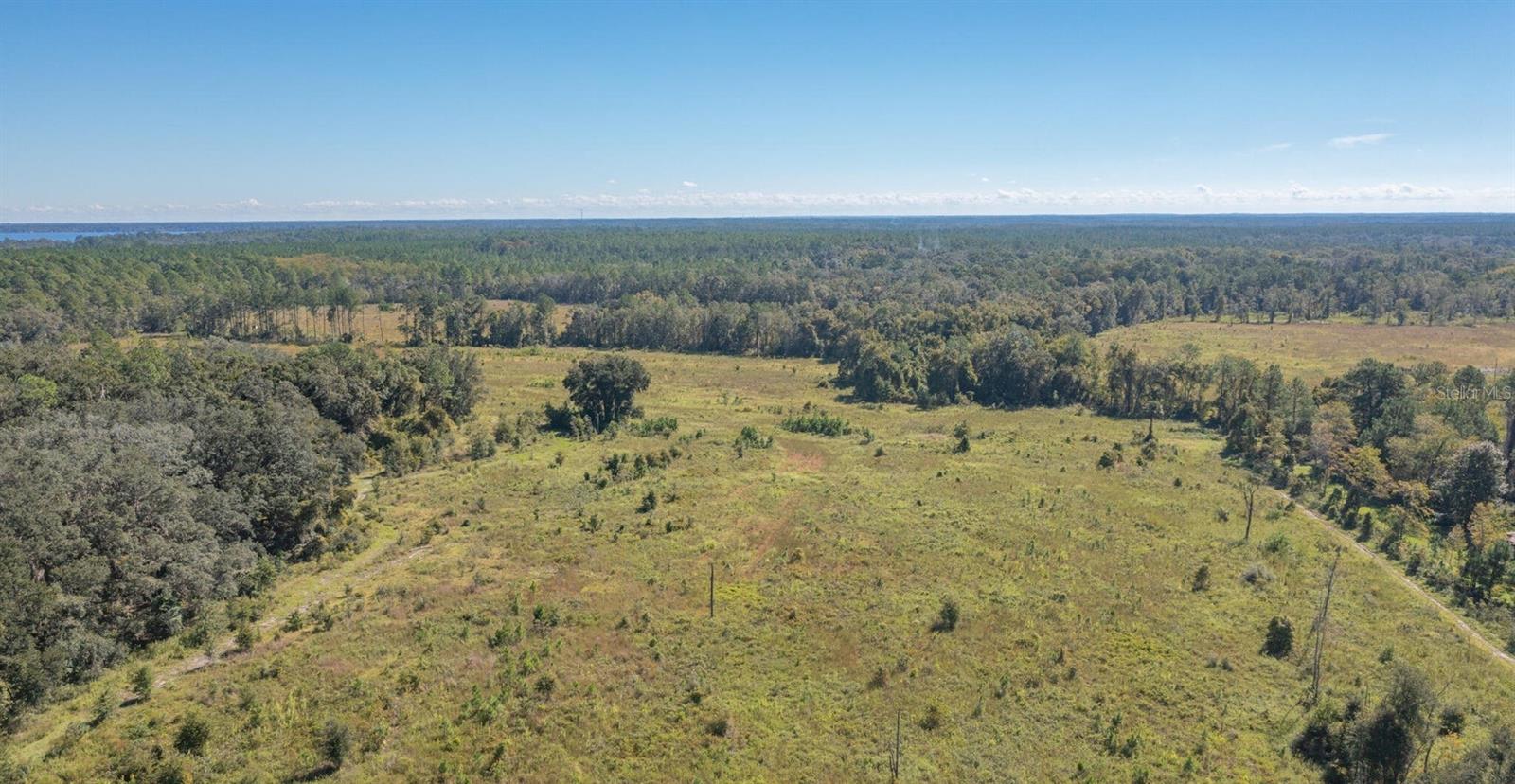 Prime Land Opportunity - 11.5 Acres with Timber & Wildlife! Here's your chance to own 11.5 acres of beautiful North Florida land, previously used for tree farming and recently replanted with long-leaf pines just two years ago. The property is mostly cleared, offering a perfect balance of open space and natural surroundings. An abundance of wildlife, including deer and wild turkeys, roam freely, making this a haven for nature lovers or recreational use. Located just minutes from the charming town of Melrose—known for its local art galleries, restaurants, and access to numerous lakes—and only 20 minutes to the Gainesville Regional Airport. Additional Land Available (see map in documents): 63 adjacent acres with several approved variances for future development An additional 20 acres at the rear of the property is also available Whether you're looking to invest, build, or enjoy a private getaway, this land offers rare flexibility and potential in a prime location.