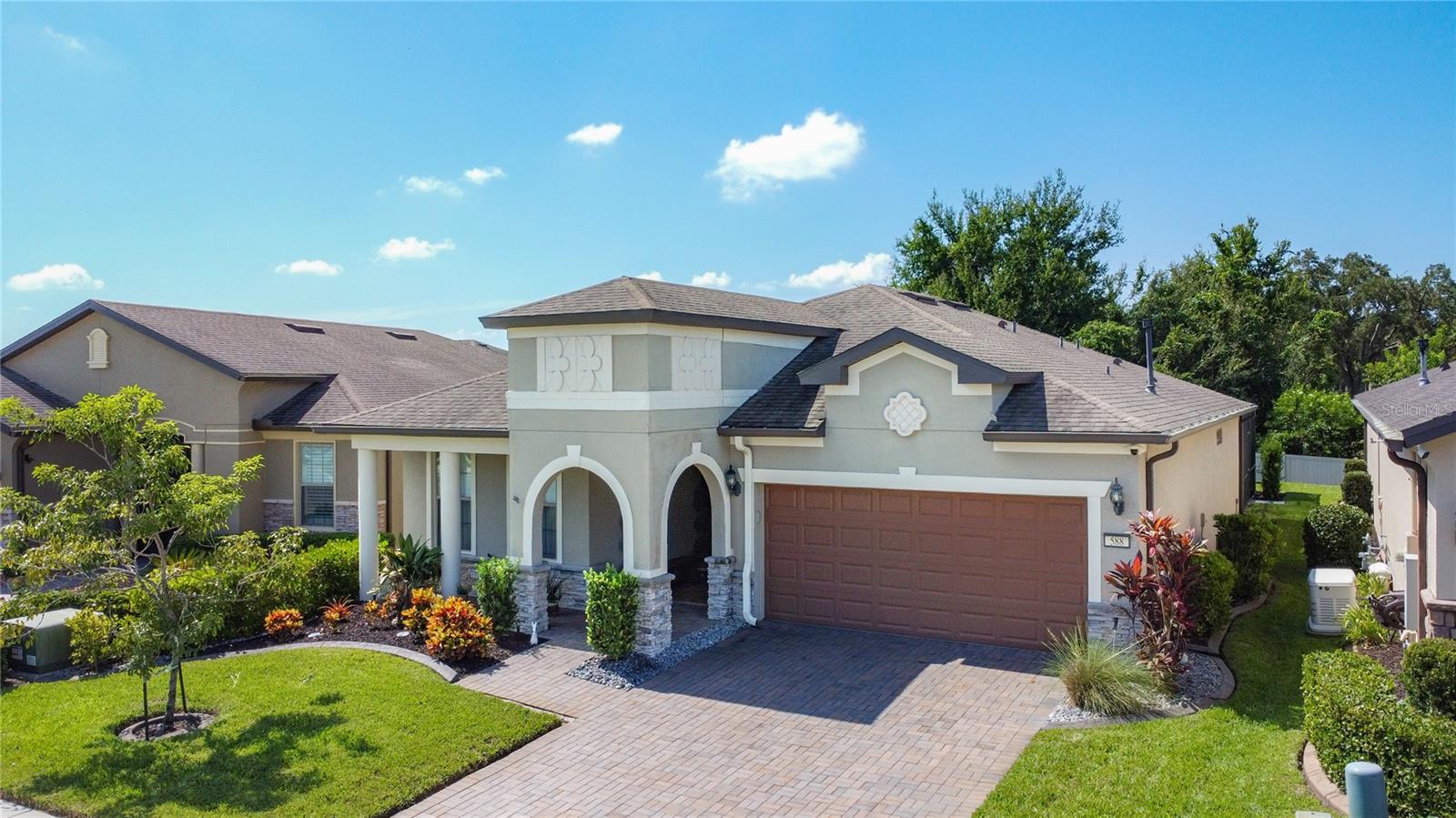Welcome to 588 Cantabria Drive, where comfort, style, and easy Florida living come together in the sought-after 55+ gated community of Del Webb Orlando. This beautifully maintained 2-bedroom, 2-bathroom plus den home sits on a premium lot and features one of the largest custom screened lanais you’ll find in the neighborhood—over 1,020 sq ft of solid concrete flooring with integrated LED lighting, offering a private, low-maintenance outdoor oasis perfect for entertaining, relaxing, or enjoying the peaceful breeze with no bugs in sight. Unlike pavers, the solid concrete patio is not only easier to maintain but also offers a sleek, cohesive look that elevates the entire backyard space. Step inside to a thoughtfully designed Pulte Abbyville floor plan with wood-look tile flooring throughout the main living areas, a spacious open-concept kitchen with rich cabinetry, granite countertops, stainless steel appliances, custom backsplash, and a generous pantry. The kitchen flows into a welcoming living and dining space, filled with natural light—ideal for both quiet nights in and lively get-togethers. The primary suite offers a walk-in closet and en-suite bath with an oversized walk-in shower and dual sinks. The guest bedroom and full bath are tucked toward the front of the home for added privacy, and the den/flex room with French doors is perfect for a home office or hobby space. You’ll also find a full-sized laundry room and a 2-car garage with an automatic opener. Del Webb Orlando is known for its resort-style amenities including indoor and outdoor pools, fitness center, walking track, pickleball, tennis, bocce ball, shuffleboard, and a full-service tavern—all nestled behind the gates with 24-hour security. Plus, you’re just minutes from I-4, Posner Park, hospitals, golf, and the magic of Central Florida’s world-renowned attractions. This is more than a home, it’s a lifestyle. Don’t miss your chance to own a rare, screened lanai retreat in one of Central Florida’s top 55+ communities. Schedule your showing today!