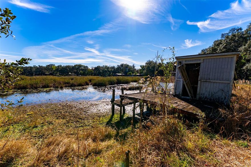 MOTIVATED SELLERS BACK ON THE MARKET "HANDY MAN SPECIAL." THIS PROPERTY IS ON LITTLE LAKE KERR CANAL IN BEAUTIFUL SALT SPRINGS ONF. Enjoy fishing, boating, hunting, ATV trails, Nature Trails, Located near Lake George and many Springs!!! This home needs LOTS OF TLC! Cash ONLY! Must have listing agent accompany showing. Several  NICE workshop/outbuildings, Greenhouse and  HUGE Storage building. Landscaped with gorgeous Oak trees! For yearly $100 fee you can use the Kerr Shores Community Center/Boat Ramp/Lake Access!
Photos show "As Is' clean up and make it yours~