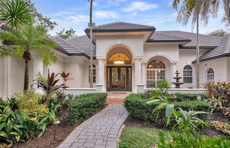 Situated at the end of a cul-de-sac behind the gates of The Oaks, this 4 bedroom home w/1 bedroom guest house has 2 offices, four full and two half baths, exudes warmth and charm. Beautifully set on a 26,000 ft2 verdant lot, the rich vegetation gives the home a feeling of calm, tropical privacy. Meticulously maintained and beautifully updated, this home is perfect for every-day-living, and entertaining. The center island kitchen features quartz countertops. Plan your meals at the built in chef’s desk or work on your laptop as your loved ones sit at the breakfast bar at the start of a busy day. Or enjoy your first cup of coffee in the breakfast nook, with large aquarium windows, and look out on the lovely pool with pavered deck, and the lush landscaping beyond. The family room, just off the kitchen, has pocket sliders to the poolside covered terrace. The formal living with fireplace, and dining room, also open to the terrace. The spacious and luxurious master suite, and two guest suites are located on the first floor. Upstairs you will find a large bonus room, with private terrace, that has the potential to be used in any number of ways. Will it be your library, study, studio, or used as another bedroom suite? The possibilities are endless. The one bedroom guest cottage has a private entrance, living room and kitchenette and views of the two lakes. A covered outdoor kitchen completes this lovely home. The recently installed back fence gives you peace of mind for your children and pets.  Membership in The Oaks, Sarasota’s premier golf and country club, is required with home ownership. Featuring two championship golf courses, lighted pickleball courts, 12 HAR-TRU tennis courts (5 lighted), a state-of-the-art fitness center, croquet lawn, and a vast array of dining and social options, the Oaks is situated close to the gorgeous local beaches, and all the shopping, cultural and recreational offerings of Downtown Sarasota.