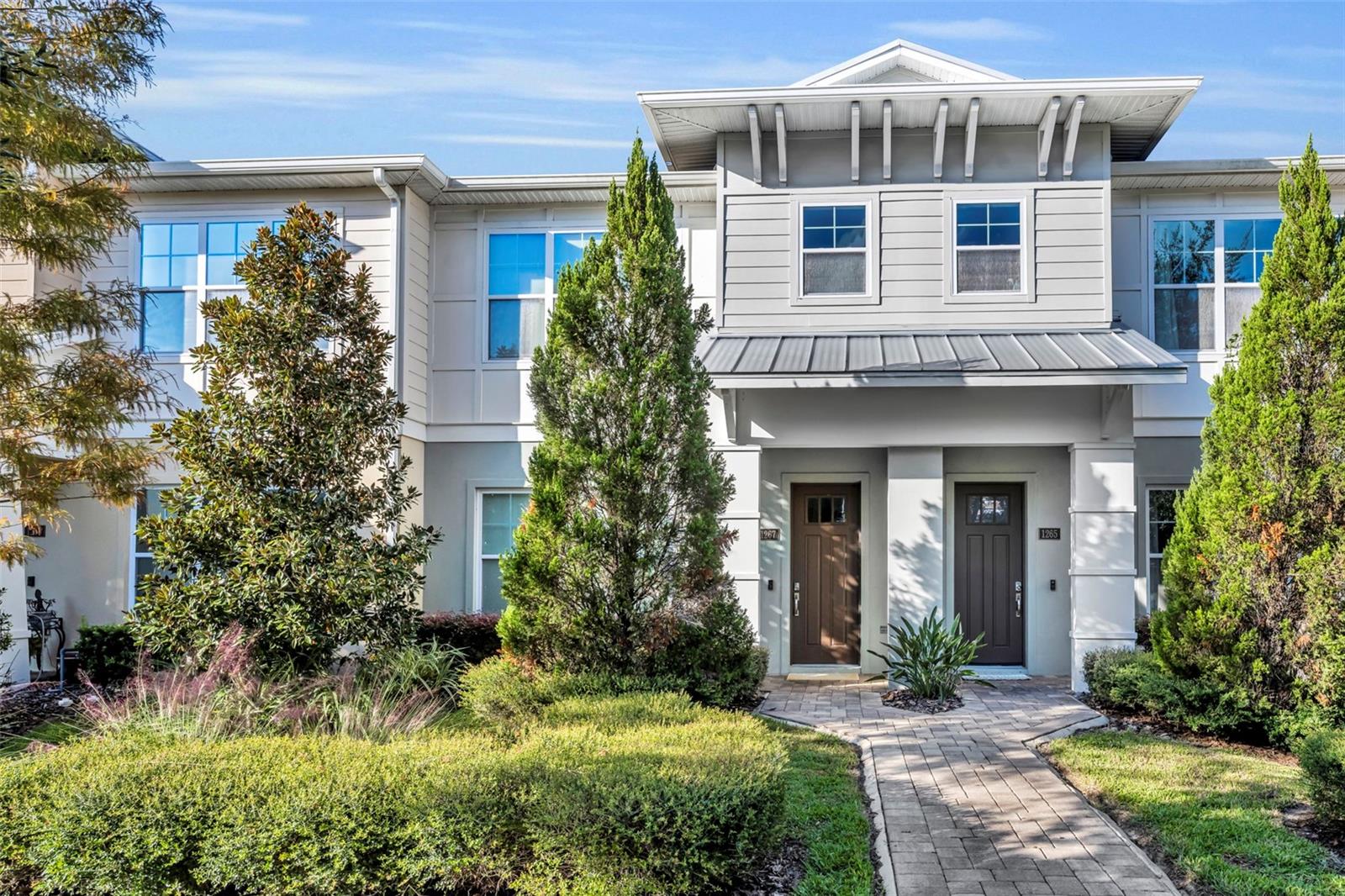 One or more photo(s) has been virtually staged. Modern Comfort in the Heart of Winter Park! Built in 2019, this 3-bedroom, 2-bath, 1,798sf townhome offers the perfect blend of convenience and contemporary style in a private 12-unit community. Light and bright with high ceilings and tile floors, the open-concept living area features a quartz island kitchen with Samsung appliances, solid wood cabinetry, and a retractable sliding door that opens to a walled courtyard—ideal for dining and entertaining. Upstairs, you’ll find the spacious primary suite, two additional bedrooms, a secondary bath, and a laundry room. Additional features include a downstairs custom closet, upgraded sound system with subwoofer and speakers throughout the main living areas and patio, central vacuum, security system, and an attached two-car garage. Enjoy low-maintenance living close to I-4, College Park, Park Avenue, shopping, and dining.