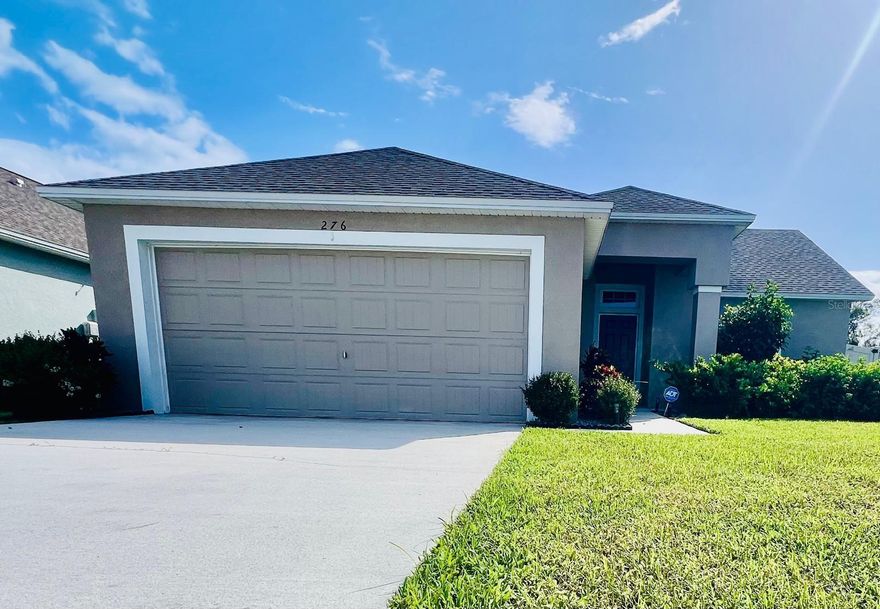 Welcome to this beautifully upgraded 3-bedroom, 2-bathroom home in the desirable gated community of Sanctuary by the Lake in Winter Haven. Nestled along the shores of Lake Rochelle, part of the renowned Chain of Lakes, this property offers the perfect blend of comfort, style, and lakeside living. The semi-open-concept layout includes a bright living and dining area with glass sliders overlooking the large, fully fenced backyard, with plenty of space to add a pool. The double garage provides ample parking and storage. The kitchen is both stylish and functional, boasting quartz countertops, stainless steel appliances, 42” wood cabinetry, and a spacious pantry. There is also a laundry closet that includes a washer and dryer. The primary suite offers a relaxing retreat with a walk-in tiled shower and an oversized walk-in closet. Residents enjoy exclusive access to Lake Rochelle for kayaking and water sports, along with scenic walking trails, private docks, and a playground—all with low HOA fees and no CDD. The property’s convenient location offers easy access to shopping, medical centers, dining, and major attractions such as LEGOLAND, Disney World, and Universal Studios. Don’t miss this opportunity to live in a beautiful, move-in-ready home within a sought-after lakefront community!
