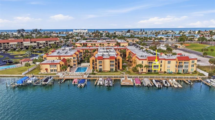 Welcome to your turnkey fully furnished coastal retreat in the resort-style gated community of Boca Shores, directly on Boca Ciega Bay and a ½ mile stroll from Treasure Island’s Sunset Beach and the Gulf of America.  Full WATERFRONT unit, beautifully updated and furnished second story 2 Bed 1 Bath Condo with sweeping unobstructed views of the wide Intracoastal Waterway. Enjoy the stunning water view from the kitchen, dining area, living room and primary bedroom. Just off the main living area, a hallway leads to a spacious full bathroom situated between the two bedrooms.  The primary bedroom has a large window facing Boca Ciega Bay and features a large walk-in closet.  A new full size combo washer/dryer is conveniently located IN the unit, in the second bedroom.  Brand new wood-look porcelain plank tile throughout gives a coastal vibe.  The condo has newer windows and sliding doors plus switch-operated hurricane shutters to add protection and peace of mind.   The all weather lanai with its sliding doors and screens brings the outside in and offers panoramic views and refreshing Intracoastal breezes.  Association amenities include a waterfront heated pool, fishing dock with cleaning station, clubhouse and fitness center (currently under construction), indoor bicycle storage for a nominal fee, two laundry rooms and more.  A reasonable monthly condo fee of $855 includes items like exterior maintenance, exterior insurance, grounds and pool maintenance, water, sewer, trash, cable and internet.  BOATERS!  There are boat slips directly in front of the unit, with electric and water, that can be leased for a monthly fee from the Association when available (slips open as of listing date).  Boca Shores is very PET FRIENDLY, allowing owners two pets, with size restrictions.  This home is well suited for permanent residents as well as investors, with a minimum lease term of 30 days.  The 5.4- acre St. Pete Beach Egan Park is located directly next door and has tennis and pickleball courts, ball fields, a public boat launch and a walking area for you and your pets.  Near Boca Shores you will find a great selection of restaurants - many with live music, the Corey Avenue shopping district, as well as a fun Sunday market where you'll find fresh foods, vegetables and crafts.  Only a 30 min drive to TPA and PIE or 20 min to vibrant downtown St Petersburg.  This is a dream purchase for water lovers.  Schedule your private tour today!
