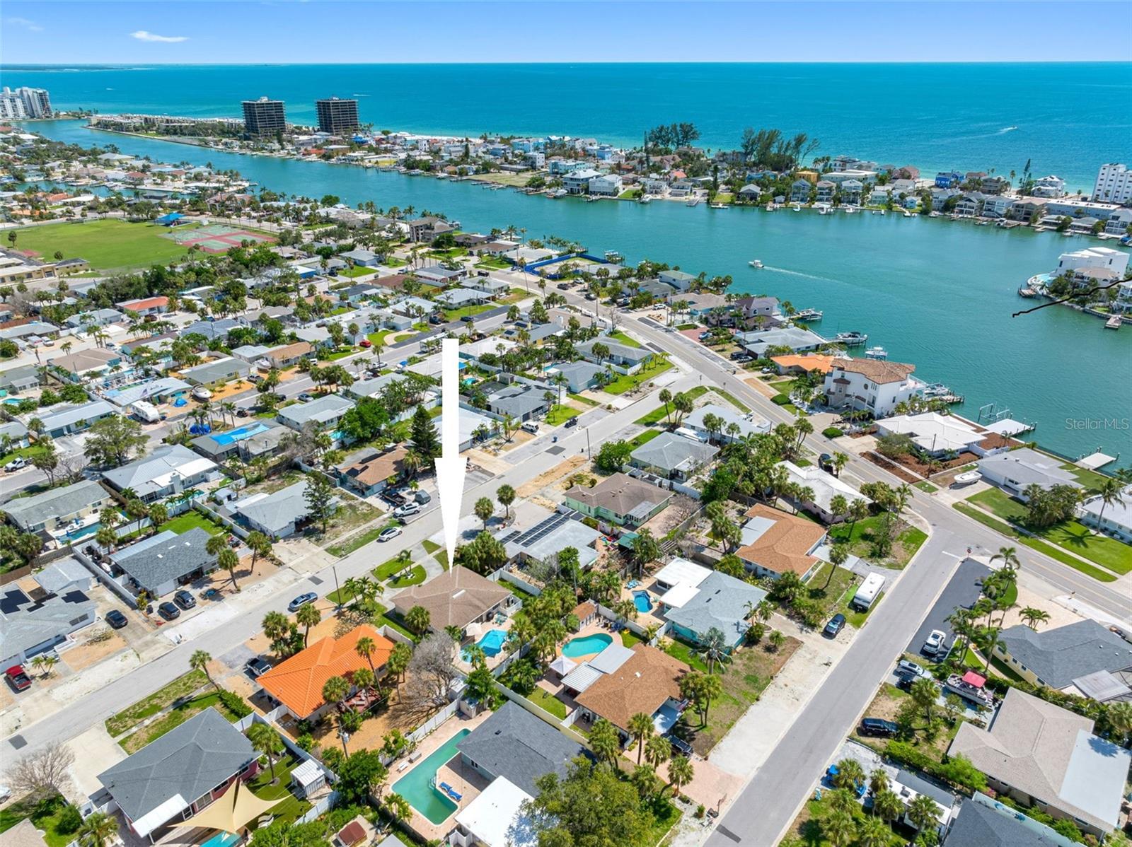 This move-in-ready, updated renovated home in the beautiful coastal city of St. Pete Beach, has been permitted and approved by the City of St. Pete Beach, offers an opportunity to own a piece of paradise. The residence is designed to reflect a tropical aesthetic, with many rooms offering views of the outdoor area that includes a heated and cooled pool with spa. The property incorporates several notable features, including impact-rated windows and doors, which provide enhanced protection and potential energy efficiency. A newer air conditioning system is in place, providing climate control. The interior features terrazzo flooring throughout the home. The dining area includes built-in shelving, offering storage and display space. The property also benefits from a circular driveway, providing ample parking for residents and guests. In St. Pete Beach, the home is positioned within proximity to the Gulf of Mexico and the St. Pete Beach Downtown Corridor which features a variety of shops and restaurants. Downtown St. Petersburg, with its art galleries, dining options and concert venues, is also easily accessible. For travel, the property is conveniently near St. Pete-Clearwater Airport and Tampa International Airport.