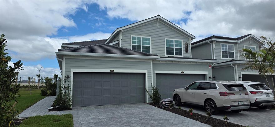 Welcome to luxury living in Calusa Country Club, where golf course lifestyle meets effortless first-floor convenience. This beautifully designed Arrowhead coach home offers 1,741 square feet of thoughtfully designed living space and comes with a golf membership included, making it the perfect opportunity to enjoy resort-style living from day one.  This single-story residence features a modern open-concept layout, seamlessly connecting the dining area, kitchen, and spacious living room—ideal for both entertaining and everyday comfort. Large sliding glass doors lead to a covered lanai, creating the perfect indoor-outdoor setting to relax and enjoy the Florida lifestyle.
The owner’s suite is privately positioned at the rear of the home, offering a peaceful retreat complete with a spa-like bathroom and a generous walk-in closet. Two additional bedrooms are located near the front of the home, providing flexibility for guests, family, or a home office.  Additional highlights include a two-car garage with extra storage space, low-maintenance coach home living, and access to the incredible amenities of Calusa Country Club.  Experience the best of golf course living with included membership, all from the comfort and convenience of this first-floor home.