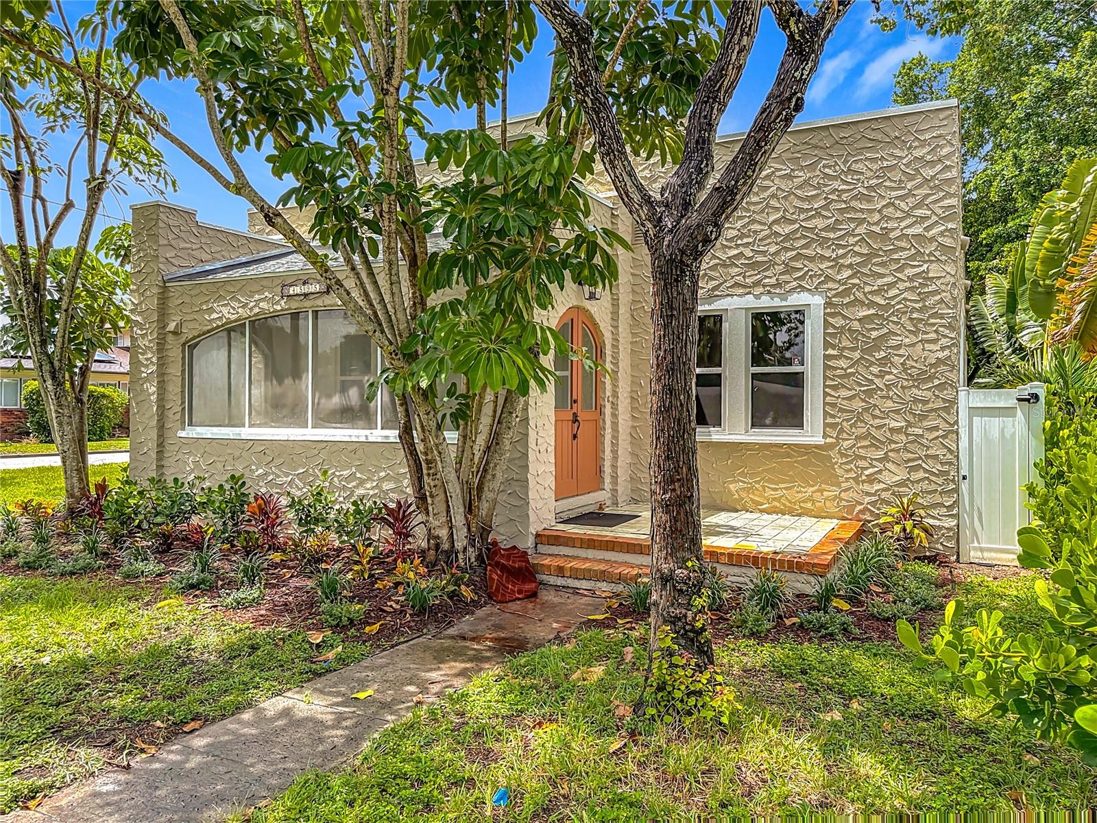 Welcome to this charming home located in the heart of El Dorado Hills, one of St. Pete’s best-kept secrets. Set on a corner lot with mature landscaping and curb appeal to spare, this 3-bedroom, 1.5-bath home offers a rare mix of historic character and thoughtful updates.
Inside, you’ll find beautiful original hardwood floors, high ceilings, and a spacious living room anchored by a classic brick fireplace. Hurricane-grade windows flood the space with natural light, and a bright sunroom offers the perfect spot for a home office, reading nook, or relaxing morning coffee. The layout flows easily into the dining area and kitchen, offering plenty of space and brand-new appliances.
All three bedrooms are well-sized, with the primary easily accommodating a king-sized bed and additional furniture. The two secondary bedrooms also offer generous space and versatility—perfect for guest rooms, home offices, or flex spaces to suit your needs. This home has been updated where it counts: a new roof (2022), new HVAC system(2023) , and new appliances (2025) offer peace of mind. A spacious backyard and rear patio make a perfect setting for outdoor entertaining, gardening, or quiet evenings at home. Located in a quiet residential pocket of Central St. Pete, El Dorado Hills offers easy access to the best of the city. You're just minutes from vibrant downtown St. Pete, the Grand Central District, and the popular shops and restaurants along Central Avenue. The award-winning Gulf beaches are less than 15 minutes away, making weekend getaways a breeze. Whether you're looking for a move-in-ready starter home or a unique historic property to make your own, this one checks all the boxes.