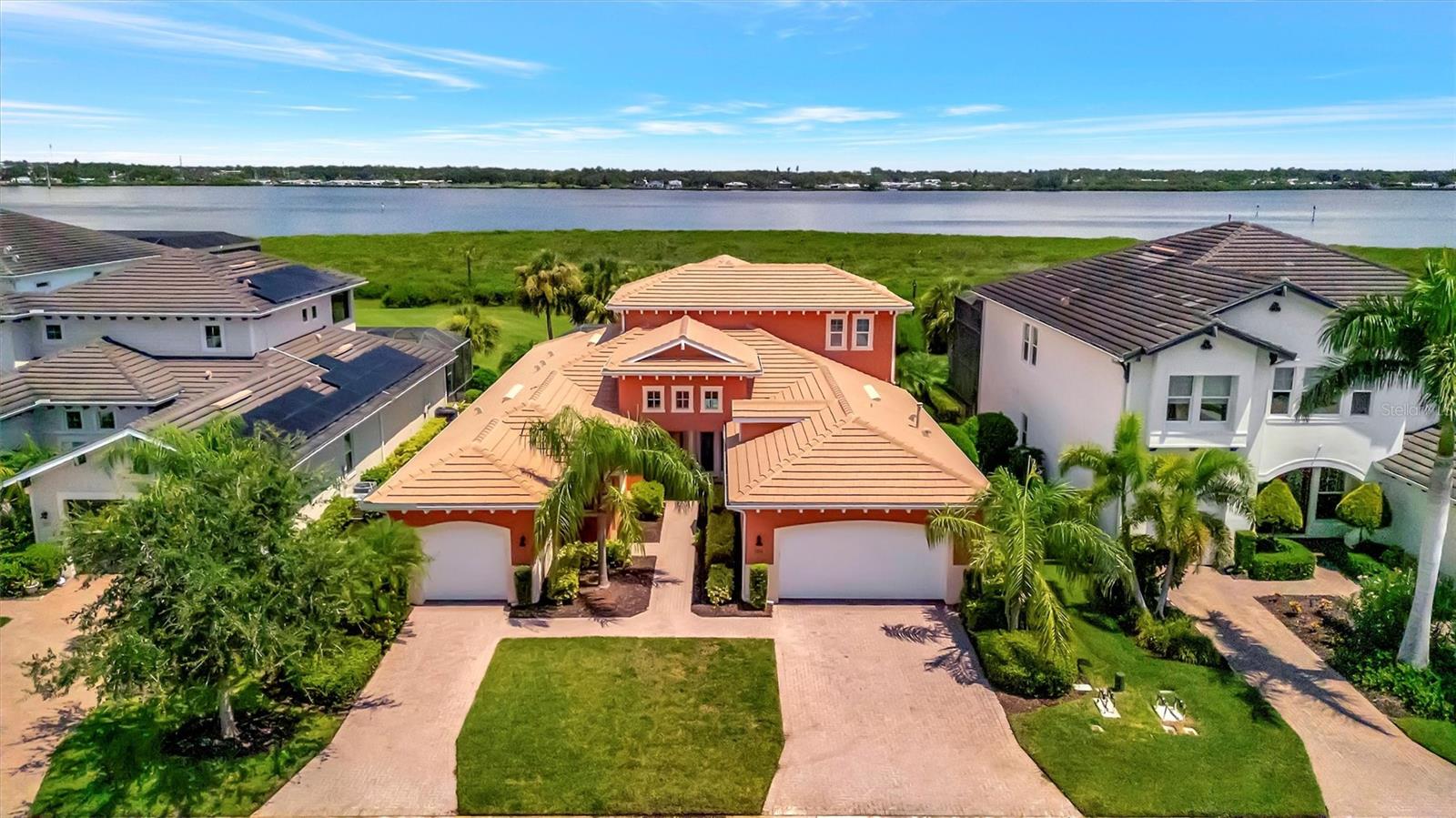 Luxury Riverfront Living in Tidewater Preserve – Bradenton's Premier Boating Community. Come tour this exceptional Asti model, perfectly positioned on the Manatee River in one of Bradenton’s most sought-after waterfront communities. This thoughtfully designed home features hurricane-impact windows throughout, 3 ensuite bedrooms + den, 4 full bathrooms, and 2 half baths, along with a spacious 23' x 17' bonus loft complete with its own 22' x 11' screened, covered balcony, wine/coffee bar, surround sound, private bath, and three storage closets—ideal for entertaining or creating a private retreat. Inside, the chef’s kitchen offers stainless steel appliances, granite countertops, a gas stove, and a walk-in pantry. The primary suite, overlooking the peaceful Manatee River, includes coffered ceilings and a luxurious spa-style bath with dual vanities, a clear glass-enclosed shower, and a soaking tub. Additional features include a 3-car garage, teak shelving in all closets, crown molding throughout, and an exceptional outdoor living space with a large, covered lanai, pool, spa, outdoor kitchen, and a full-size cabana bath—all with breathtaking riverfront views. Tidewater Preserve is a 24-hour manned, guard-gated waterfront community offering resort-style amenities, including three pools, a clubhouse, marina, dog park, walking trails, kayak/canoe launch, and easy access to I-75, dining, shopping, and more.