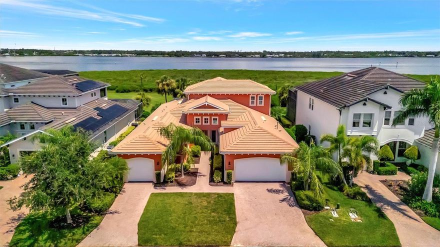 Luxury Riverfront Living in Tidewater Preserve – Bradenton’s Premier Boating Community. Come tour this exceptional Asti model, perfectly positioned along the Manatee River in one of Bradenton’s most sought-after gated waterfront neighborhoods. Designed for both comfort and peace of mind, this home features hurricane-impact windows throughout—eliminating the need for shutters and allowing you to enjoy river views even during storms. Inside, you’ll find three ensuite bedrooms plus a den, four full bathrooms, and two half baths. A spacious 23' x 17' bonus loft adds incredible flexibility and includes its own 22' x 11' screened, covered balcony, wine and coffee bar, surround sound, private bath, and three storage closets—ideal for entertaining or creating a private retreat. The chef’s kitchen is outfitted with stainless steel appliances, granite countertops, a gas stove, and a walk-in pantry. The primary suite overlooks the peaceful Manatee River and features coffered ceilings and a spa-like bath with dual vanities, a clear glass-enclosed shower, and a soaking tub. Throughout the home, you'll appreciate thoughtful touches like teak shelving in every closet and elegant crown molding. Step outside to enjoy a true outdoor oasis. The large covered lanai, sparkling pool, relaxing spa, outdoor kitchen, and full-size cabana bath all come together to create a perfect space for entertaining—set against the breathtaking backdrop of the river. Tidewater Preserve is a 24-hour guard-gated waterfront boating community offering resort-style amenities including three pools, a clubhouse, marina, dog park, walking trails, fitness centers, kayak and canoe launch, and easy access to I-75, dining, shopping, Sarasota, and Tampa.