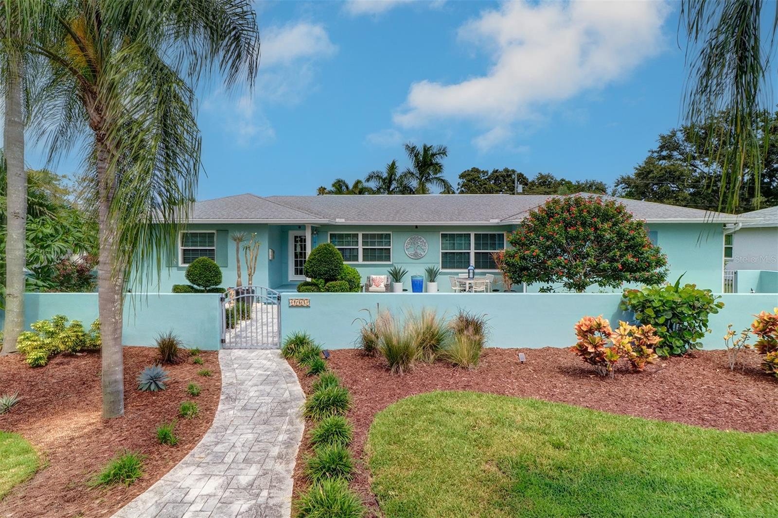Welcome to your tropical oasis in the heart of St. Petersburg. This expansive, meticulously cared-for modern ranch offers over 2,000 square feet of bright, airy living space with a thoughtfully designed split floor plan. Step into comfort and sophistication in this beautifully designed home featuring an extra-large living room that serves as the perfect centerpiece for both everyday living and entertaining. The open layout enhances flow and flexibility, while large windows frame serene views of the surrounding property. With three bedrooms and three full baths, this residence offers the ideal layout for families, professionals, or anyone seeking a stylish retreat. Rich light chestnut brown engineered hardwood floors flow throughout the home, adding warmth, elegance, and timeless appeal to every room. The heart of the home is its fully remodeled kitchen, where form meets function in every detail. Crisp white cabinetry pairs beautifully with Cambria quartz countertops, offering ample prep space and a clean, modern aesthetic. A gas cooktop, dual oven, and GE Café Series refrigerator with built-in Keurig ensure that both everyday meals and gourmet creations are a breeze. Modern pendant lighting adds warmth and elegance, while the oversized bar doubles as a casual dining space and gathering hub. Whether you're cooking breakfast or hosting a dinner party, the large picture windows and glass doors frame the swaying palms and sparkling water, creating a seamless indoor-outdoor experience. It's a space designed not just for cooking, but for connection—with nature and with the rhythm of relaxed Florida living.
The private owner’s retreat is a true sanctuary, featuring a spa-like bathroom with a freestanding soaking tub, glass-enclosed shower, double vanity with quartz counters, and two customwalk-in closets by California Closets. The home features two versatile secondary bedrooms, each thoughtfully designed for comfort and functionality. One bedroom includes a stylish custom Murphy bed that folds out effortlessly, blending form and function with integrated lighting and built-in storage. The second bedroom is currently being used as a dedicated home office, offering a quiet and productive environment ideal for remote work or creative pursuits. Both rooms are outfitted with California Closets systems, providing efficient storage solutions that maximize space and organization. Step outside to a lush tropical paradise where palm trees sway over a resort-style saltwater pool with a sun deck. The backyard has been completely transformed with new landscaping, fruit trees, composite decking, and a double walk-out patio. The front courtyard features a paver patio, in-ground fountain, artificial turf, and a five-hole putting green. Additional upgrades include hurricane-rated PGT windows and doors, a whole-house Generac gas generator, a gas water heater, a new white vinyl fence, a Tuff Shed for extra storage, and a widened driveway with space for three cars. The garage has been enhanced with epoxy flooring, overhead storage racks, and a custom workbench and cabinetry by California Closets. In 2024, the home received a new, upgraded A/C system with all-new ductwork for enhanced efficiency. Also, located in a NON-FLOOD zone offering peace of mind.
Every inch of this home reflects thoughtful design and quality craftsmanship, offering a rare blend of luxury, and resort-style living just minutes from the beach and downtown.