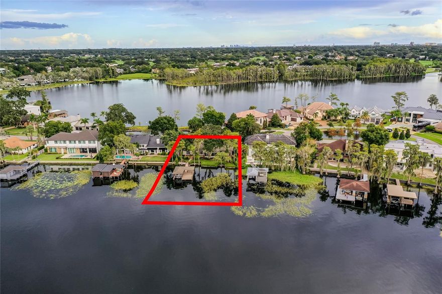 LUXURIOUS LAKEFRONT LIVING with UNPARALLELED views on Lake Tibet Butler of the famed Butler Chain of Lakes, in Bay Point! It doesn't get much better than this for a homesite of this caliber, and GATED, within the desirable confines of Bay Hill. This amazing waterfront lot is .37 acres, with 95' front feet, and includes a remodeled dock with covered boat slip & hoist, built with TREX. The custom 3-bed, 3-bath ranch, 1-story home was built in 1979 and is a prime candidate for a major remodel, vertical expansion, or removal for a new build. The scarcity and value of the lot alone are unsurpassed. Bay Point consists of 40 homesites, 30 on the water, its own HOA, gated, private roads, yet a 3-minute golf cart ride to Arnold Palmer's Bay Hill Club and Lodge. Also, ALL of the services and conveniences in SW Orlando/Dr. Phillips, including the Sand Lake corridor, is unmatched. There is a required application process for residency. This is the rarest of opportunities to live on these Lakes.