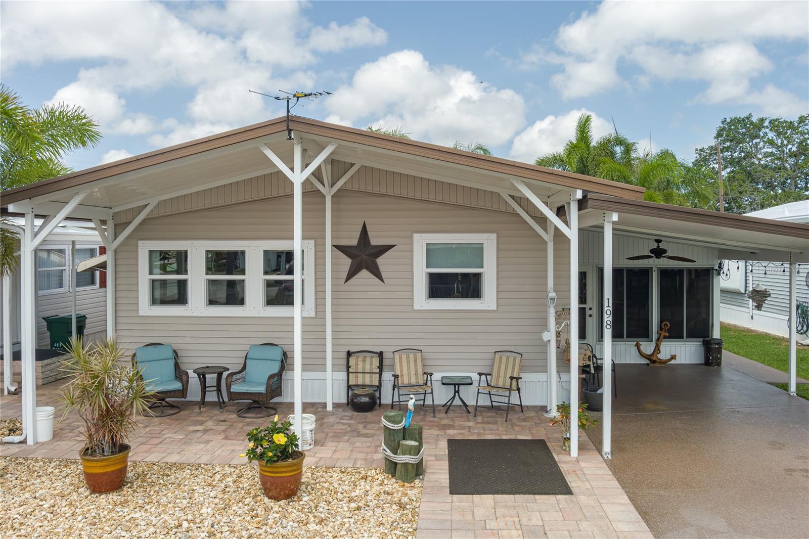 Charming & Fully Renovated 2-Bedroom Home in Jet Mobile Home Park – Furnished & Move-In Ready! Don't miss this beautifully updated 2-bedroom, 2-bathroom home in the highly sought-after Jet Mobile Home Park, a resident-owned 55+ waterfront community along the Manatee River. Offered fully furnished, this cozy and inviting home is ideal for a seasonal retreat or full-time Florida living. Step inside to find a bright and airy open-concept layout with a spacious sunroom for added comfort. Recent updates completed in 2025 include new floor insulation, new vinyl flooring, fresh interior paint, updated vanities and plumbing, and a new shower in the second bathroom. The kitchen features a custom-built hickory design, complemented by a new dishwasher and split A/C units installed in 2025. The A/C condenser was also raised 4 feet off the ground for improved efficiency and durability. A new washer and dryer were added in 2025, and a microwave, electric range, and disposal are included. Additional home improvements include vinyl thermopane windows, new siding, awnings on all exposed windows, and a durable white rubber roof (2023). A front roof extension with a lanai and carport was built with proper engineering, and the home has been professionally treated for termites. A 4-point inspection was completed on May 16, 2025 for added peace of mind. This home is listed at appraised value, giving buyers confidence in its price and condition. The property comes partially furnished, including a master bedroom suite and some additional furniture. You'll enjoy low HOA fees of just $195/month, which cover water, sewer, garbage, and lawn care. The average monthly electric bill is around $100. The community also offers a private boat ramp, kayak launch, pool, shuffleboard courts, and a clubhouse with social activities. Located just minutes from Ellenton Premium Outlets, the beautiful beaches of Anna Maria Island, and three international airports, this home is perfectly positioned for both relaxation and convenience. This home is truly turn-key and packed with value—schedule your private showing today!