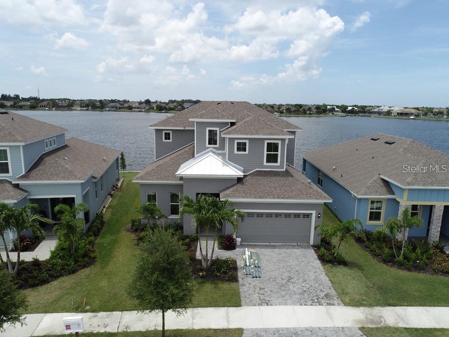 Welcome to MiraBay!
This stunning waterfront home offers four bedrooms, three and a half baths, a dedicated home office, and an upstairs loft. The main living area boasts soaring 23-foot ceilings and wide plank tile flooring throughout.
The primary suite is conveniently located on the main floor and features expansive lagoon views, a walk-in closet, a seamless glass shower, and a separate deep soaking tub.
Enjoy cooking in the gourmet kitchen, which includes a farmhouse sink, quartz countertops, a spacious island, and gas appliances. Home does come with Washer & Dryer.
Upstairs, you’ll find a large loft overlooking the water along with three additional bedrooms.
MiraBay is a gated community with incredible resort-style amenities including basketball, tennis, and pickleball courts. Residents also enjoy access to parks, playgrounds, clubhouse, fitness room, sauna, on-site cafe, pools, and a thrilling 26-foot water slide. Paddleboards, kayaks, and canoes are available free of charge for residents.