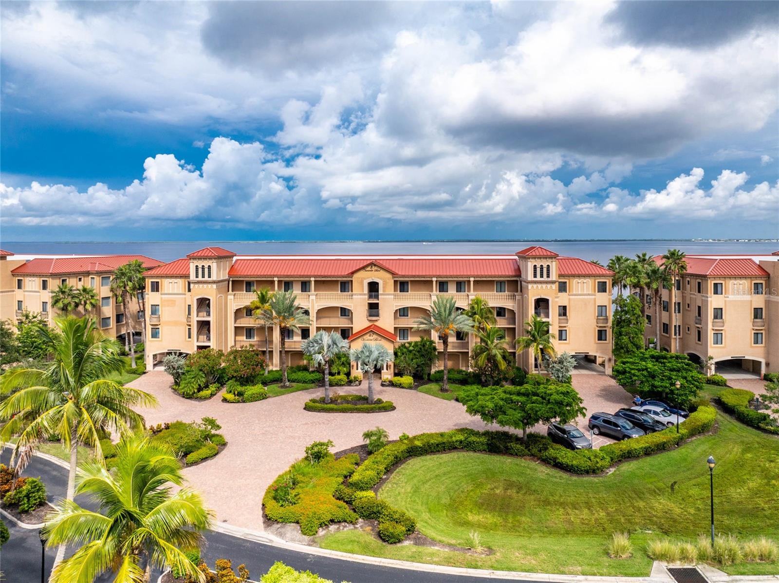 LUXURY WATERFRONT LIVING WITH UNFORGETTABLE SUNSETS OVER CHARLOTTE HARBOR! Each evening feels like a private show as the sun sinks over Charlotte Harbor, painting the water and sky in brilliant color. From this second-floor residence in Vivante at Punta Gorda Isles, you'll enjoy a view framed by lush mangroves and palms that give way to the harbor beyond. The setting blends the beauty of Florida's natural landscape with the drama of wide skies and breathtaking sunsets, creating a view that is both serene and inspiring. A private elevator opens to a welcoming foyer and sets the tone for a home designed for elegance and comfort. Broad windows, soaring ceilings, and an open layout maximize light and frame the harbor at every turn. Living and dining areas extend seamlessly onto a spacious screened lanai, where breezes and sunsets create the perfect backdrop for coffee, casual gatherings, or evenings spent with friends. The lanai becomes a natural extension of the home, inviting you to relax outdoors while still feeling connected to the living space inside. The gourmet kitchen features granite countertops, custom cabinetry, stainless appliances with designer hood, a powered island, and a breakfast bar designed for conversation. Abundant storage keeps the space refined and functional. The primary suite is a retreat with direct lanai access, dual walk-in closets, and a spa-inspired bath with split vanities, soaking tub, walk-in shower, and private water closet. Two additional guest suites are generously sized with walk-in closets, and one offers its own en-suite bath for added privacy. Practical features complement the design, including multiple storage closets, a private garage storage room, a full laundry with sink and washer/dryer, and a deeded oversized under-building parking space. Vivante is Punta Gorda's premier gated waterfront community, where resort living is part of every day. The 12,000-square-foot clubhouse includes elegant lounges, a billiards room, and a state-of-the-art fitness center with sauna. Two heated pools and a spa invite relaxation, while six Har-Tru tennis courts host friendly and competitive play with a seasonal pro. Residents also enjoy a full-service spa, group fitness classes, and a lively calendar of social events. Beautifully landscaped walking paths, shaded gathering areas, and secure entry add to the atmosphere of a private retreat. Whether your morning begins with yoga, a workout, or coffee overlooking the harbor, each day here feels elevated. Evenings can include a swim, tennis under the lights, or cocktails on your lanai as the sky reflects across the water. Just minutes away, historic downtown Punta Gorda offers waterfront parks, the Harborwalk, galleries, live music, boutique shopping, and destination dining. Spend the afternoon exploring open-air markets, enjoy dinner along the water, or attend one of the city's many cultural festivals that celebrate art, music, and food. For those who love the water, Charlotte Harbor provides direct access to open waterways, perfect for boating, sailing, or fishing. Every detail of this residence is designed to impress, from its refined interiors to its resort amenities. Yet it is the harbor itself that makes it truly special. With sunsets that transform the horizon and views framed by Florida's natural beauty, this is more than a home. It is a lifestyle beautifully realized at Vivante.