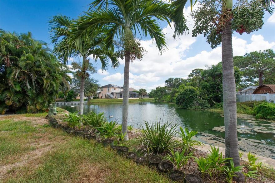 Look no further! Immerse yourself in the mesmerizing TROPICAL LAKEFRONT views the moment you set foot in this lovely and turn-key 1980-built block home! Owner window-enclosed the 360sqft back porch and installed a mini-split A/C unit/ heat pump (increased htd. sqft to 1760). The entire home is wheelchair accessible with wide entrances to the master bedroom and Ensuite bathroom/ Deluxe accommodation plus a huge walk-in closet. Easily maintained tile floors throughout the house, a new stylish, functional kitchen with QUARTZ COUNTERS,  "KitchenAid" appliances, pantry, and large pass-through window into the Florida room (dining area) for endless tranquil views over the serene lake (76ft waterfront). Other features include all high-impact windows with interior custom shutters & shades, sliding glass doors, split bedroom floor plan, linen- and storage closets, numerous ceiling fans, several rustic-look barn doors, a water filtration system, front storm door, fabulous large inside laundry room ("Amana" washer/ dryer convey) with additional storage, new A/C in 2019, an oversized 2-Car Garage, paved double driveway, newer electric panel box, tankless "natural GAS" water heater, new shingle roof with soffits and gutters in 2021, flat roof/ sunroof in 2024, GAS Generator in 2018, manual sprinkler system draws from the lake, small wood dock with gate for lake access, and a new seawall in 2017. Enjoy your morning coffee year-round watching the sunrise, wildlife, turtles & birds from the private screen back porch. The 0.23 acre lot is all vinyl fenced with gates, and offers a large man-cave shed with electric, on the side of house. Secluded "Carriage Bay/ Bay Pines Lakes" community (Seminole Fire district) is located a few minutes from Bay Pines Veteran Memorial Park & VA Hospital, scenic Pinellas Trail, Bay Pines Marina, Madeira Beach (Johns Pass Village), Tyrone Mall, new Seminole City Center, Seminole Rec Center, St. Pete College, a variety of nearby dining & entertainment options, 20 minutes to vibrant downtown St. Petersburg & a 30 minutes' drive to Tampa International Airport. Hurry, and see this inviting home today - purchase before Dec. 31st and take advantage of the 2026 homestead exemption or use as an investment for income!