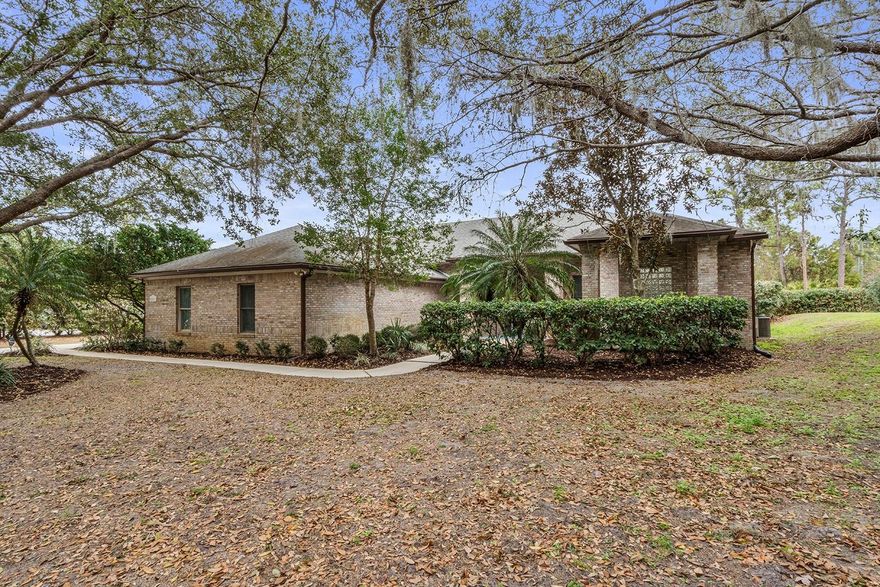 Welcome home to this FABULOUS 3 way SPLIT plan 4 bedroom, 3 1/2 bath SCREENED POOL gem!! This beautifully manicured 1 acre lot has mature trees and landscaping. With DEEDED access to pristine LAKE PICKETT, you can launch your boat or jet skis from the private beach area.  As you enter the home's large foyer, there is a SEPARATE dining room and living room.  An office or flex space is on the same wing as the primary bedroom.  Here you will find HARDWOOD FLOORING, tray ceiling, sitting area and his/her closets.  The ensuite bathroom has a large WHIRLPOOL tub, dual sinks, GRANITE countertops and a large stand alone shower.  Onward to the second wing of the home, INSIDE LAUNDRY, 1/2 bath and 2 additional bedrooms with a jack and jill bathroom.  The kitchen features GRANITE countertops, TILE backsplash, wine and coffee area, breakfast bar and a breakfast nook and NEWER appliances.   It overlooks the family room with a WOOD burning fireplace.  Off the family room, is the 4th bedroom suite with NEW carpet.  This is perfect for guests or in-laws.  The UPDATED bathroom gives an added touch to this third wing of the home.  CROWN MOLDING throughout the home, roof is from 2018, water heaters NEW 2026, HVAC NEW 2026.  The covered lanai area is perfect to relax and enjoy your morning coffee.  The NEW pool screens and NEWLY sealed pavers give this retreat even more finishing touches. Extra storage in the extended 2 car garage for a small workshop or golf cart area. Seminole County Schools, 10 minutes to shopping, 45 minutes to the beaches, 20 minutes to UCF and Seminole State College.  This well desired neighborhood is the perfect mix of where country meets luxury!! Schedule your tour today!!