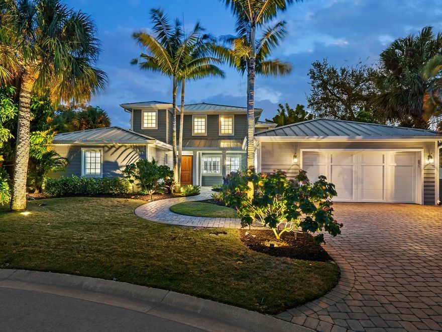 Luxury meets tranquility on the serene shores of Siesta Key. Nestled at the end of a quiet cul-de-sac, this coastal contemporary residence offers a 5-bedroom, 4-bath oasis overlooking 120 feet on the Grand Canal's deep boating water. From the front entry, you're greeted by a beautifully remodeled open-concept floor plan seamlessly connecting the great room, dining area, and chef-inspired kitchen. The kitchen is a haven for culinary enthusiasts with an oversized island, perfect for meal prep and casual dining, white shaker cabinets, quartz counters, and top-of-the-line JennAir stainless steel appliances. Enjoy casual meals in the breakfast nook with banquette seating; a planning desk is ideal for organizing your day in paradise. The main living areas boast floor-to-ceiling sliding glass doors open to the expansive screened lanai, offering breathtaking panoramic waterway views. Whether entertaining guests or enjoying a quiet evening at home, the lanai and waterfront patio provide the perfect setting to relax and dine alfresco while soaking in the balmy island breezes and picturesque sunsets, making it easy to host gatherings with family and friends year-round. provide The first-floor primary suite is a true retreat, featuring serene waterfront views and two walk-in closets. Glass French doors open onto the sparkling pool and spa area, creating a seamless indoor-outdoor living experience. Pamper yourself in style in the spa-like bath, a subway-tiled walk-in shower, and a luxurious Kohler-heated bubble massage air tub. Additionally, there are two quartz-topped vanities, a linen closet, storage, and a private water closet for added convenience. Two additional bedrooms and a full bath with modern fixtures are located on the main floor, providing comfortable accommodations for family and guests. The convenient laundry room offers added functionality and ease of living. Upstairs, a fabulous bonus room awaits, perfect for hosting guests or creating a private retreat for kids and teenagers. Custom built-ins house a media center, while two spacious bedroom suites offer walk-in closets and private baths with elegant quartz counters and designer fixtures. Step out onto the large balcony overlooking the waterway, where you can enjoy peaceful moments of reflection. The spacious outdoor area beckons for fun in the sun and shade. Shell stone pavers surround the south-facing freeform pool, creating an inviting oasis for relaxation and recreation to entertain friends and family. A composite dock and 10,000-pound boat lift are ready for watersport enthusiasts, offering easy access to the open waters of Sarasota Bay and the Gulf of Mexico. The fenced yard offers room for kids and pets to play safely, while lush tropical landscaping enhances the beauty and privacy of the property.
An extensive 2013 renovation includes a new roof, kitchen, baths, flooring, plantation shutters, plumbing, and concrete siding, ensuring modern comfort and style. In the evening, fabulous outdoor lighting illuminates the paver drive and tropical gardens, creating a magical, welcoming ambiance and enhancing the home's curb appeal. Siesta Key's world-famous crystal quartz sands and aqua waters await a few minutes away. Unique Siesta Village awaits with shopping and dining options to suit every taste. Discover the cultural richness of downtown Sarasota, with its array of restaurants, theaters, ballet, opera, museums, galleries, and shopping destinations, all just a short drive away.
