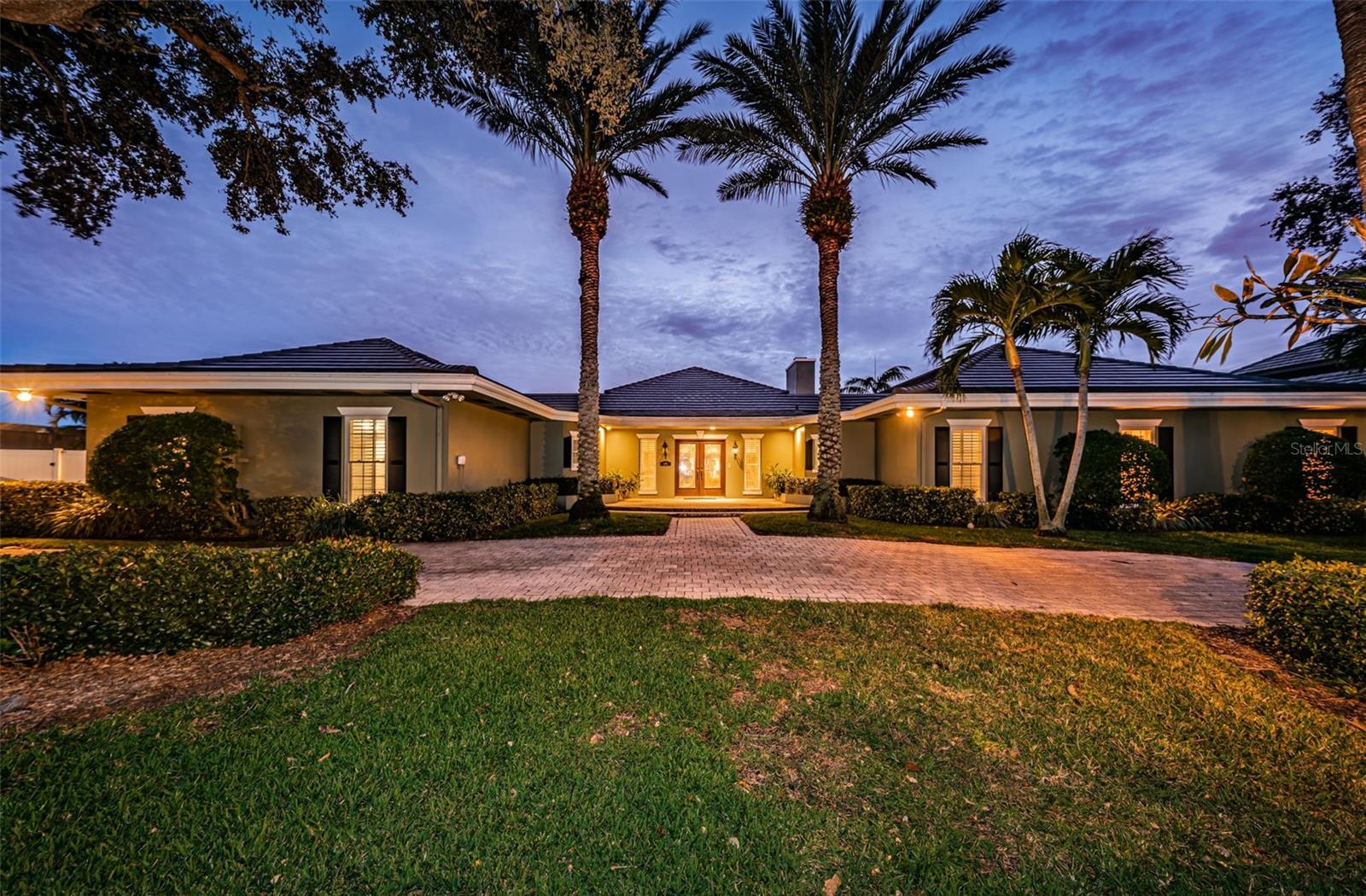 ***ACCEPTING BACKUP OFFERS***
STUNNING VIEWS OF THE GLISTENING WATERFRONT greet you immediately as you
enter the dramatic glass double front doors into the luxurious foyer of this well-appointed home in exclusive Bayway Isles. Gorgeous curb appeal, with designs by renowned landscape architect Phil Graham, draw you in to the home complete with upscale, custom finishes throughout. Pass the foyer and into a warm and spacious formal living room with fireplace and sliders to the slate and travertine decks overlooking the water. The living room adjoins a formal dining room providing easy access to the spacious chef’s kitchen, boasting Dácor double ovens, twin Miele dishwashers, custom wood cabinets, Subzero refrigeration and more. The superb eat-in kitchen and adjoining family room share views of the water with access to one of two spacious screened porches for enjoying a morning coffee or an evening drink. A spacious and grand owner’s suite is complete with his and hers walk-in closets, custom built-ins, and a lovely en suite bathroom with convenient walk-in shower. The 3 additional bedrooms also each feature built in storage structures and en suite baths with solid surface counters. The real star of the property is the location! Situated on an oversized lot with more than 160’ of seawall frontage, the home offers the finest in outdoor Florida living. A NEW cement tile ROOF was installed in 2023. The seawall itself is a newer build (2015) and sits a foot higher than the surrounding sea walls. A composite wet dock of over 1,000 sf of area harbors both a 6,000 lb boat life and a vast multi-point mooring slip for a large boat. Sit on the dock and admire porpoises, manatees, and myriad other sea life year-round. Or, with deep water at the end of the dock, you have a wonderful opportunity to keep a sailboat or larger cruising vessel for easy access to Boca Ciega Bay and the Intracoastal Waterway, where you are mere minutes to the Gulf of Mexico. It’s a boater’s dream! Your pool and spa, both newer (2017) and heated by propane, offer year-round fun and relaxation as you bask in the Florida sunshine and gaze dreamily at the limitless waterfront. When you must leave your paradise home, rest assured that you are mere moments from one of the world’s top-rated beaches and just 10 minutes to downtown St Petersburg’s bustling waterfront and restaurant scene, and just 25 minutes to Tampa International Airport.
