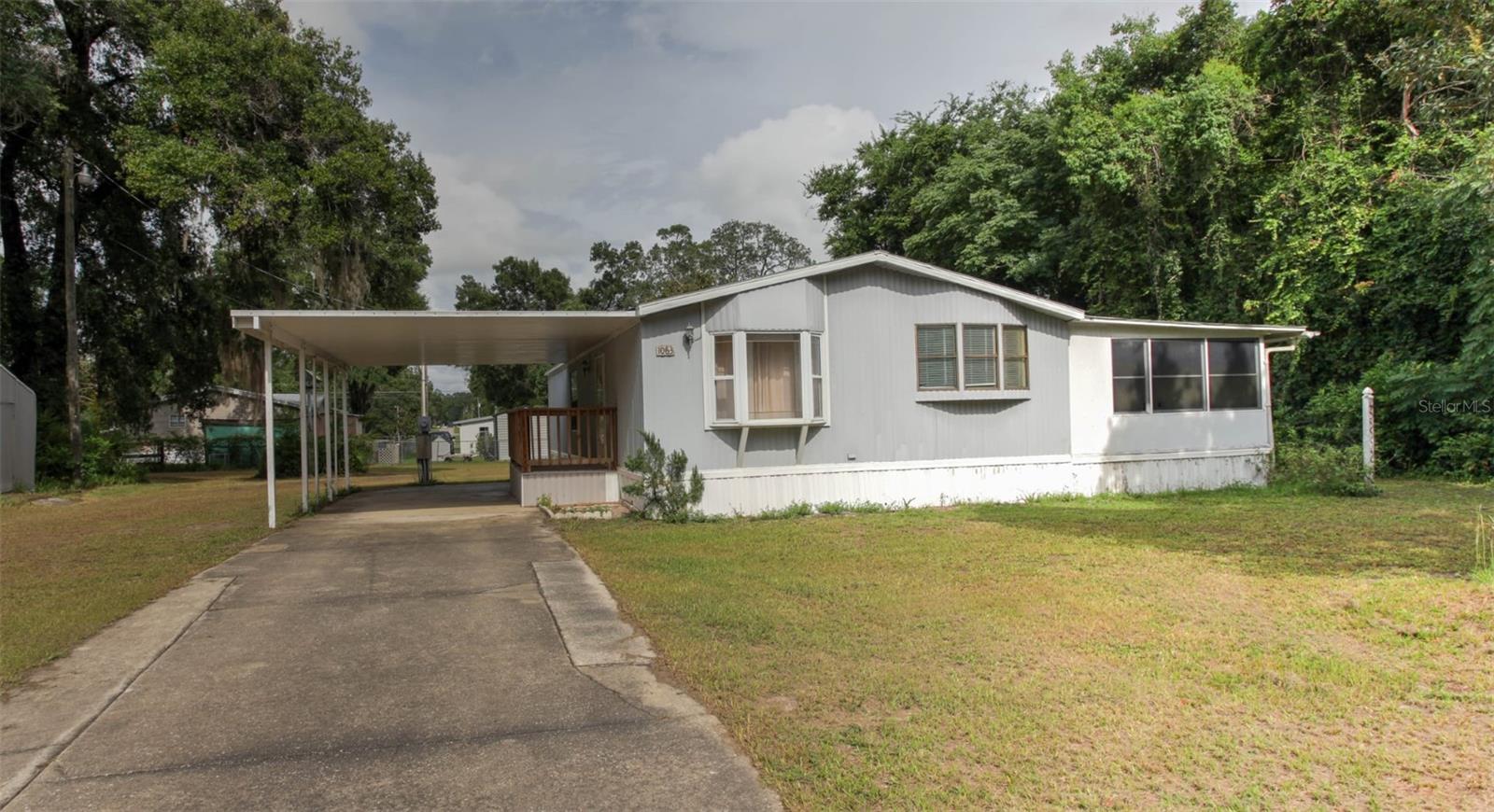 Charming 2 Bedroom, 2 Bath Manufactured Home on Nearly Half an Acre! Don’t miss this great opportunity to own a well-maintained home situated on a spacious, fenced lot. This 2 bed, 2 bath home offers a bright Florida room, covered carport, and two storage sheds for all your tools and toys. Whether you're looking for a cozy primary residence or a smart rental investment, this property checks all the boxes. Plenty of outdoor space to enjoy, with room for a garden, pets, or even a workshop. Schedule your showing today!