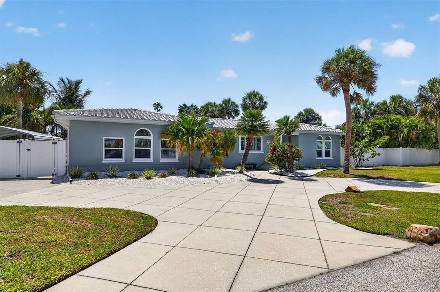 One or more photo(s) has been virtually staged. Tropical breeze and palm trees -- welcome home to coastal luxury and comfort in the prestigious enclave of Carlouel in Clearwater Beach! One of the few homes offering coveted PRIVATE beach access this home is a must see! Spend your days lounging in your private pool soaking in the sun and sipping tropical beverages or enjoying all the outdoor activities Florida has to offer. This beautifully updated 4-bedroom, 3-bath POOL home offers the perfect combination of convenience and modern beach living -- just steps from the Gulf of Mexico as well as an exclusive peaceful and secluded resident-only beach access! Situated on an oversized, fully fenced lot, this exceptional Clearwater Beach property is designed for both entertaining and everyday comfort. Inside, you’ll find coastal boho finishes, soaring ceilings with exposed beams, and wonderful natural light at every turn. A stunning newly renovated kitchen featuring granite countertops, stainless steel appliances, custom cabinetry, and an oversized island that seamlessly opens to the main living spaces. Rich hard wood flooring, plantation shutters, and thoughtful finishes create warmth and sophistication throughout the home. The luxury of both living and oversized family rooms allow for ample space to entertain family and friends. 
The spacious indoor-outdoor layout flows effortlessly to a screened lanai overlooking your private backyard oasis complete with a sparkling swimming pool, hot tub, outdoor shower, and lush tropical landscaping. Multiple outdoor gathering spaces make this home ideal for both relaxation and hosting guests year-round. 
Additional highlights include a circular driveway, covered carport, gated side access on both sides of the property, extra parking for golf carts or beach toys, and a storage shed for added convenience.
Located in one of Clearwater Beach’s most exclusive and golf-cart-friendly communities, Carlouel offers unmatched tranquility while remaining minutes from world-famous white sand beaches, waterfront dining, marinas, shopping, and entertainment. Rarely do homes become available in this prestigious enclave offering private beach access, oversized lots, and true coastal charm. Whether you're seeking a year-round residence or a vacation getaway, this beach house is the perfect place to call home. Don't miss your chance to experience the best of Clearwater living—where every day feels like a vacation! Schedule your tour today!