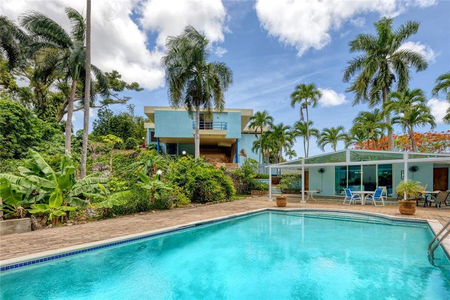 Majestically perched atop a boulder in an impressive display of architecture, this residence harmoniously blends into its picturesque natural surroundings. Enjoy awe-inspiring views of Guaynabo and San Juan's scenic landscapes. The exceptional property provides new owners an open canvas to remodel and customize to their taste. Four bedrooms plus office, six bathrooms and one partial are exquisitely showcased throughout the unique open layout. The sizable pool, Jacuzzi, outdoor kitchen and multiple balconies serve as some of the home's many highlights. A laundry, maid's room and 3-car garage are also conveniently provided.

Located within the exclusive gated community of Tintillo Hills, unequaled privacy and tranquility in an ideal setting. Near top academic institutions such as Baldwin School and the distinguished military base of Fort Buchanan. A short drive away from San Juan and Dorado, offering residents beautiful scenery and a serene atmosphere while still being in close proximity to the metro area.