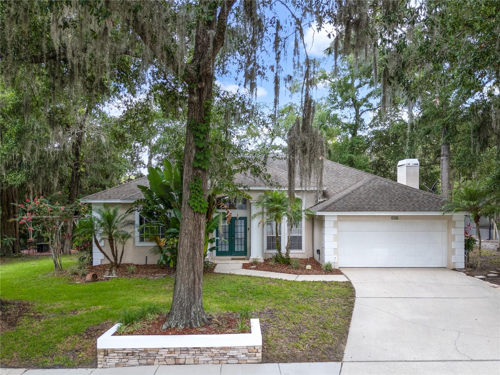 Welcome to 116 Winding Oaks Ln — a charming contemporary-style ranch home in one of Oviedo’s most desirable, well-established neighborhoods. Act quickly—this home is priced to sell and ready for your offer. Nestled on a spacious .31-acre lot, this beautifully maintained 4-bedroom, 2-bath home offers 2,164 square feet of inviting living space with serene pond views and a peaceful, tree-lined setting. Inside, you’ll find loads of windows for natural light, wood and tile flooring throughout, a cozy wood-burning fireplace, and a spacious and spa-like master bathroom. This well-thought-out home has a laundry room with a built-in ironing board and utility sink. and thoughtful features throughout. The roof was replaced in 2015, it was replumbed in 2017, and the HVAC was fully replaced in 2017 for added peace of mind. The kitchen has upgraded appliances as well as custom cabinetry. Step outside to your personal oasis: a large screened-in back porch overlooking one of the best views in the neighborhood — a tranquil community pond with a fountain, surrounded by mature trees. A pergola area has lighting and a firepit that is great for entertaining or simply relaxing under the stars. Located in a peaceful, well-established neighborhood with a community park, this home offers convenient access to Oviedo on the Park and a variety of nearby amenities. It's situated just minutes from Lawton Elementary School, Oviedo High School, and the scenic Cross Seminole Trail. With a blend of timeless character and modern updates, this property offers comfort and convenience in a prime Oviedo location.