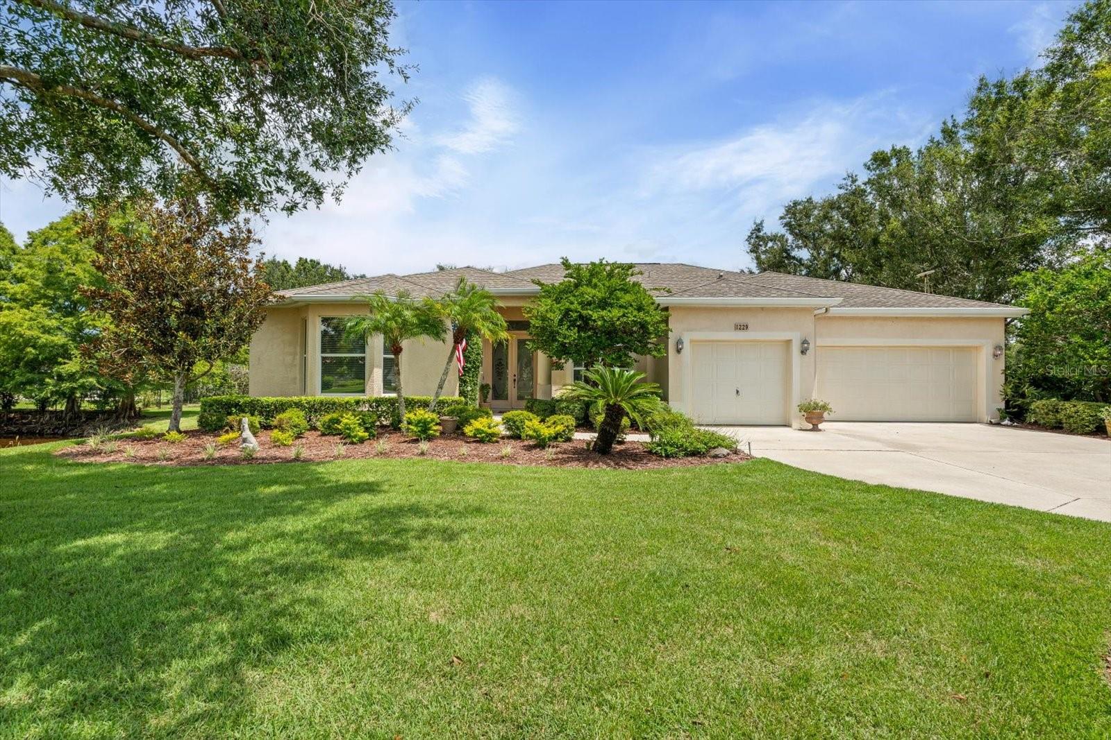 Nestled on over an acre of beautifully manicured and mature landscaping, this custom-built Augusta model, featuring 3 bedrooms, 2 baths, and a den, offers a rare combination of elegance & comfort. The beautiful double glass front entry with matching transom windows sets the tone, opening to soaring 12-foot ceilings, refined crown molding, and an abundance of natural light. The Family room is anchored by a lovely wood-burning fireplace, while the den features Bay Window with custom built-in seating, blending functionality with architectural charm. The gourmet kitchen is the heart of the home, showcasing a granite-topped island, premium finishes, and seamless flow for both intimate gatherings and grand entertaining. The expansive master suite is a private sanctuary, complete with large walk-in closet En-suite bathroom boasting double sink vanity, frameless glass shower, roman tub, and bidet. Sliding doors allow easy access to pool deck and lots of light. Practical touches such as a well-appointed laundry room with cabinetry and a utility tub access the spacious 3 car garage equipped with workbench and extra storage. Outdoors, the property embraces Florida living at its finest. A tranquil pond, shared with a neighboring property, provides the perfect setting for fishing and quiet reflection. At the same time, the surrounding grounds attract deer, turkeys, and other wildlife, not to mention abundant butterflies in the garden, creating a private nature retreat. Golf cart accessibility enhances the lifestyle, and additional features such as New Roof installed (2021), Well Pump (2025), Hot Water Heater (2022), solar film on south facing windows, a water softener all add both efficiency and convenience. Located just 30 min. from downtown Sarasota, 20 min. to Waterside LWR, shopping, Restaurants and Convenient to both Siesta and Lido’s beautiful beaches and 15 min. from the Majestic Myakka State Park. With timeless design and serene surroundings, this home is a refined retreat where luxury meets tranquility. Schedule you showing today!