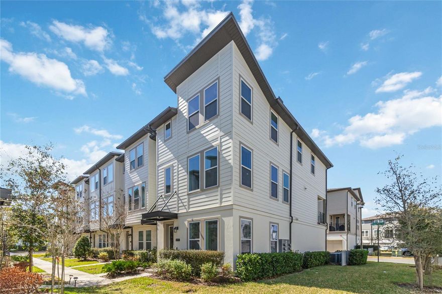 WOW!  CUSTOM DESIGNED LUXURY Ashton Woods 3 story townhome with an A+ WALKING SCORE!  This amazing home is centrally located just a short walk from the community epicenter “Laureate Park Village Center” and Zip Line Park.  Here you’ll find the LP Fitness Center, resort-style pool, and Canvas Market & Restaurant.  Not only is this home an END UNIT with tons of lighting and soaring ceilings but it is also fully customized throughout!  You’ll find luxury vinyl, custom tile and wood flooring throughout, designed glass stairwell railings, an amazing updated gourmet kitchen and 3 and a half fully customized bathrooms! STARTING ON THE GROUND FLOOR -- Your front entrance connects to a completely private guest bedroom with hall drop zone space, garage access and a fully upgraded CUSTOM ensuite bathroom with marble tiled floor to ceiling walk-in shower and walk in closet.   FROM THERE it’s just a few steps up to the 2nd floor OPEN CONCEPT LIVING SPACE which combines the family room, dining area, and a GOURMET KITCHEN featuring upgraded stainless appliances, impressive center island with quartz waterfall countertops and matching quartz backsplash, designer hardware and custom noise canceling wall treatments.  The space is completed with a second living space adjacent to a charming, covered balcony perfect for enjoying stunning Lake Nona sunsets.  WHEN YOU ARE READY TO RELAX you’ll be just a few more steps away from the primary bedroom suite and 2nd guest suite both complete with their own fully customized ensuite bathrooms and walk in closets plus a stylish laundry room. Additional features an attached two-car garage with epoxy flooring and ample guest parking near the home. HOA includes high-speed internet (up to 1 GIG), fitness center access, resort-style aquatic center, beach volleyball court, and half basketball court. Ideally located in the heart of Lake Nona’s Medical City and convenient to A-rated schools, Orlando International Airport, USTA, KPMG, top-tier shopping, dining, and entertainment.  The owners have only used this home a few times a year.  It is available furnished but furnishings will be sold separately.