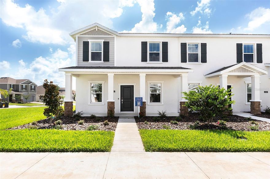 Why wait to build when you can own this never-occupied former model home in the sought-after community of Wellness Ridge. This beautifully designed end-unit townhome is filled with natural light thanks to an abundance of windows, creating a bright and inviting atmosphere throughout. Mature landscaping, a charming walkway, and a welcoming front porch provide exceptional curb appeal from the moment you arrive.

Inside, spacious living and dining areas offer the perfect setting for entertaining guests or hosting holiday gatherings. A convenient powder bath is ideally positioned on the main floor, while wood-look tile flooring throughout the first level adds both style and easy maintenance.

The open-concept family room flows seamlessly into the chef-inspired kitchen, featuring 42” upper cabinets, quartz countertops, stainless steel appliances, an oversized island with seating, and plenty of prep space for everyday living and entertaining alike. The main-floor laundry area connects to an open walkway with space for a cozy sitting area or additional flex space. Step outside to the expansive lanai — the perfect place to relax, host gatherings, or fire up the BBQ.

Upstairs, the spacious owner’s suite is privately positioned at the front of the home and features a large walk-in closet and a luxurious en-suite bath complete with dual vanities, quartz countertops, and an oversized walk-in shower. Two additional bedrooms and a well-appointed guest bath provide plenty of room for family, guests, or a home office.

Completing this exceptional home is a two-car garage and extended driveway, offering both convenience and additional parking. This move-in-ready home combines modern design, comfort, and low-maintenance living in one of Clermont’s most desirable communities.

Clermont, known as the “Choice of Champions,” is internationally recognized as a premier destination for elite athlete training, offering rolling hills, scenic lakes, and endless outdoor recreation. Historic Downtown Clermont provides a vibrant mix of culture, dining, shopping, and entertainment.
Designed for an active lifestyle, Wellness Ridge features resort-style amenities including a community pool, clubhouse, fitness center, playground, basketball court, tennis and pickleball courts, trails, and open green spaces. Residents also enjoy close proximity to Lake Louisa State Park, Southern Hill Farms, and convenient access to US-27, with Disney and Universal just a short drive away.
Located minutes from the future Olympus development, residents will be near one of Greater Orlando’s most exciting live-work-play destinations, planned to feature elite sports training facilities, hospitality, dining, shopping, luxury residences, and a vibrant waterfront Town Center.