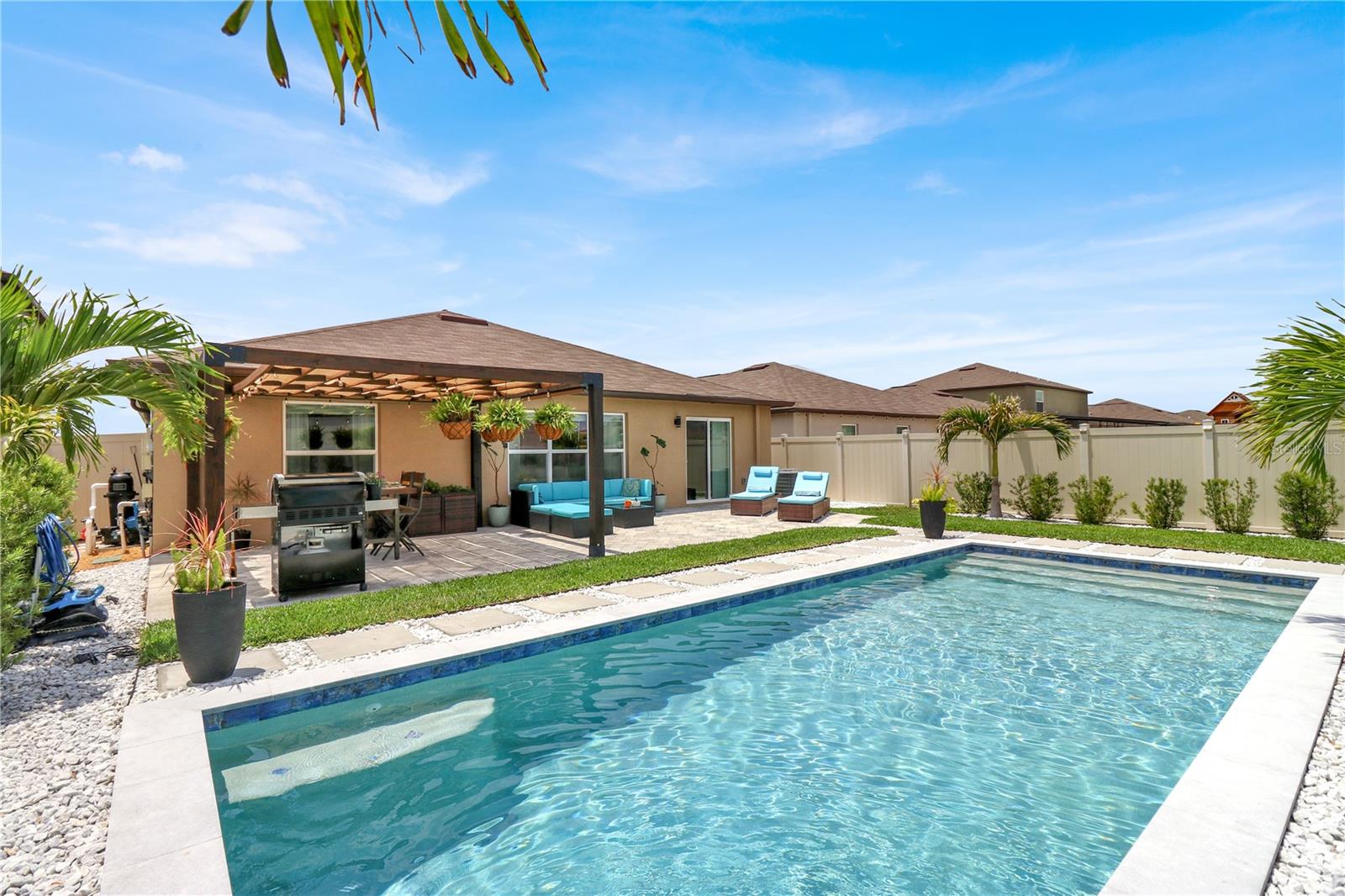 ** Back on the market - buyers financing fell through. Asking price bellow appraised value, building instant equity ** Modern Comfort Meets Outdoor Luxury – Upgraded 4-Bedroom Home with Pool, Solar & Designer Touches in a Non-Flood zone. Welcome to this beautifully upgraded 2022 one-story home offering 1,935 sq ft of open-concept living with a desirable split floor plan, 4 spacious bedrooms, and 2 bathrooms. Designed for both functionality and elegance, this home blends modern finishes with thoughtful upgrades throughout. The heart of the home is the stylish kitchen featuring an upgraded pantry, seamlessly connected to the dining and living areas ideal for entertaining and everyday comfort. An upgraded laundry room and 2-car attached garage add practicality and convenience. Retreat to the primary suite, complete with brand-new, high-quality carpet and a custom walk-in closet system featuring built-in mirrors, LED lighting, ceiling fan, and a dedicated makeup vanity. The primary bathroom has been beautifully updated with hard surface countertops, an LED mirror, and a frameless glass shower door. The home offers great flexibility with a built-in Murphy bed and custom desk in the second guest bedroom—perfect as a guest suite or home office. One of the additional guest bedrooms features a built-in bookcase, creating a versatile flex space ideal for a home office, homework station, or third guest room. Step outside to your private backyard oasis, where a fenced rectangular saltwater pool is surrounded by professional landscaping, a pergola-covered dining area, and ample outdoor seating and lounge spaces ideal for relaxing or entertaining in style. Additional highlights include leased solar panels that are fully transferable to the new owner, ensuring long-term energy efficiency.