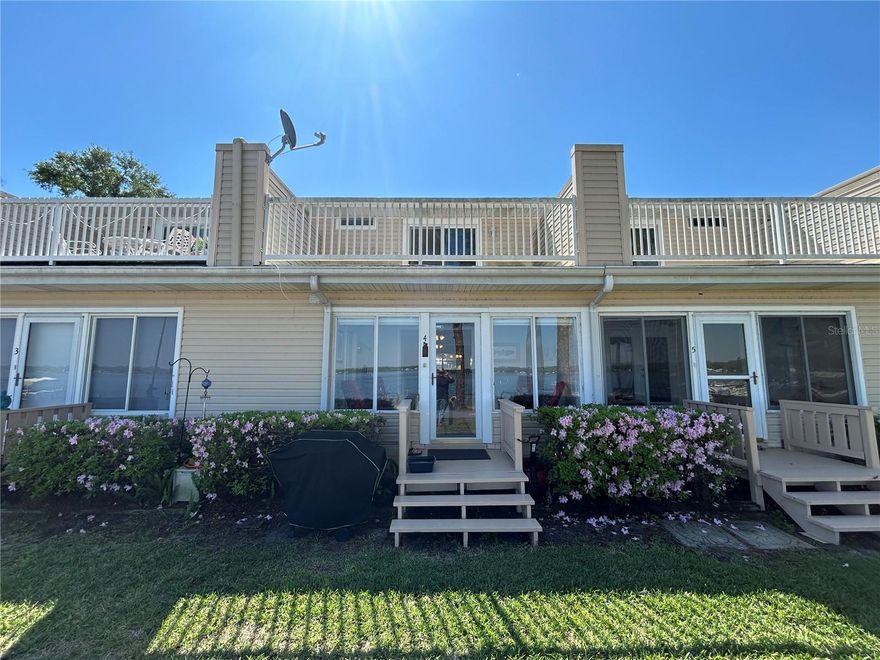 Are you ready to own your own piece of paradise on Lake Weir? This beautifully maintained condo is truly a prime waterfront location. This unit boasts two upstairs bedrooms, and two bathrooms, one half-bath downstairs and one full upstairs. You also have two amazing locations to watch the sunset over the harbor from the privacy of your own condo - the enclosed Florida room downstairs offers a wall of windows and the private balcony upstairs can be accessed through the sliding glass doors of the main bedroom. The Loch Harbor community boasts an array of amenities including a private pool, private beach and lake access, clubhouse, tennis/pickleball courts, racquetball courts and a volleyball net. You can truly have carefree living knowing that all of the exterior maintenance and repairs, including pest control and trash disposal, are all benefits of being a part of this community. Located less than 20 minutes from The Villages, you are conveniently located between peaceful lake living and access to world class shopping, dining and events. You don't want to miss this incredible opportunity!