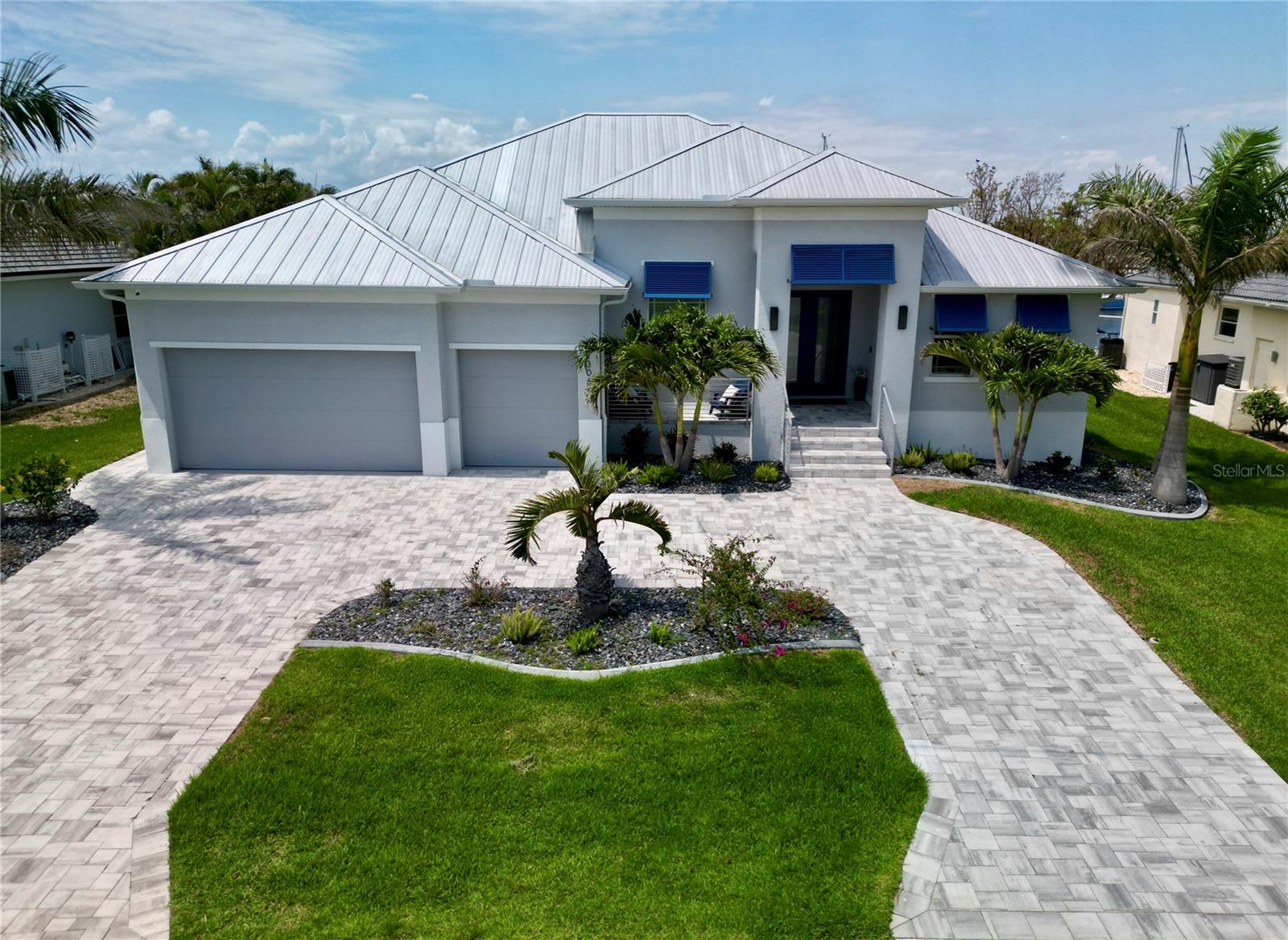 Experience waterfront luxury at its finest in this one-of-a-kind, custom-designed home, built in 2022 and located in the highly desirable Bird Section of Punta Gorda Isles. Perfectly positioned on 80 feet of city-maintained seawall with wide intersecting canal views and unrestricted Gulf access, this home is a boater’s paradise—featuring a 42-foot dock with water and electric hookups, plus a 13,500 lb boat lift.
Step outside to your private resort-style retreat, where a fully automated, extra-deep saltwater pool and spa await. The outdoor area includes a sun shelf, custom water features, mosaic medallion, and a white marble paver pool deck framed by reinforced steel and panoramic screens on all three sides. The expansive lanai is perfect for entertaining with an outdoor kitchen, outdoor shower, remote-controlled hurricane screen, and elegant welded railings.
Inside, no detail has been overlooked. Boasting three bedrooms, three bathrooms and a den, there is plenty of room for everyone. The home features oversized wood-look porcelain tile, solid core doors, and impact-resistant windows throughout. The chef’s kitchen is a showstopper with a full suite of Thermador professional appliances (including designer blue knobs), Carrara marble backsplash, seeded glass upper cabinets, upgraded pulls, and quartz and granite countertops. Custom cabinetry adds both beauty and functionality, while additional upgrades like a reclaimed wood mantle above the electric fireplace and upgraded lighting throughout the home reflect thoughtful design and craftsmanship.
Retreat to the primary suite and enjoy plantation shutters, luxurious upgraded bath fixtures with rain head and handhelds, and fully customized closets and storage throughout. Other notable upgrades include full interior wall insulation, a gas line, upgraded garage door, advanced PC Security system, and an extensive landscaping package. Ask for a full features list!
All of this, just minutes from downtown Punta Gorda, Fishermen’s Village, waterfront dining, shopping, and only 10 minutes by boat to Charlotte Harbor. With over $350,000 in high-end enhancements, and furnishing negotiable, this home is not just move-in ready—it is a turnkey masterpiece of coastal elegance.
