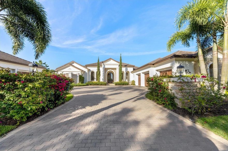 Designed with exceptional attention to detail, this custom John Cannon estate home has been beautifully re-designed with significant improvements to the interior and exterior of the home, as well as the construction of a new Guest house (Casita) overlooking the pool. Situated on a one-acre homesite, this single story home blends casual elegance with an emphasis on comfort and true indoor / outdoor Florida living. As you enter you are greeted by a gracious living room that is both elegant and cozy. Coffered ceiling beams, crown molding, and a feature wall with linear fireplace frame a cozy room overlooking the spacious pool area. The front living space has been opened up to showcase the fabulous kitchen and family room. The gourmet kitchen boasts a stunning island topped with 6 cm Calacatta Gold Lucidato marble counters, chef-grade appliances including a Wolf double oven and gas range, split Subzero refrigerator and freezer and Wolf two-drawer beverage refrigerators for added convenience. Open to the kitchen, the family room overlooks the expansive pool area with disappearing, cornerless sliding glass doors for maximum indoor-outdoor living. The travertine floors from the main living areas have been carried out to the pool deck for a seamless transition. Move beyond the family room and you’ll find a bonus room with wood paneled and beamed vaulted ceiling, and a gas fireplace, creating the perfect space for games and movies. The adjacent cabana with matching vaulted wood ceilings, a large bar, and outdoor kitchen can be closed off from the home for outdoor cooking, or it can remain open to the bonus room. The extended lanai embraces the home, creating a private oasis, with three large under cover areas with wood ceilings, including a gazebo with fireplace and large spa that flows gently into the resort style pool. Adjacent to the front living room you’ll find a temperature-controlled wine room capable of holding up to 400 bottles, a large study that features floor to ceiling built-ins, and a beautifully designed pool bath with shower. The primary suite is the perfect retreat, featuring large his and her closets with custom built-ins, a dressing room, and an elegant spa-like bathroom with walk through shower and center soaking tub. On the opposite side of the home are 3 generously sized secondary bedrooms, a side entrance hall with drop station, and a large laundry room. One of the bedrooms has been redesigned to incorporate an adjacent private den / sitting area. Across the pool you’ll find a newly added guest cabana with sitting area, kitchenette, separate bedroom and full bath. There’s an oversized 3 car garage attached to the home, as well as a detached air conditioned 2 car garage that has been converted for use as a home gym or dance studio, with mirrored wall and rubber floors.  There's a whole house generator for peace of mind, and the home is smart wired for sound, lighting and security management. The Concession Golf Club has been ranked as one of the finest private golf clubs in the country. Within the gates of Concession, there are miles of picturesque paths for running, walking and bike-riding. Excellent schools, fabulous restaurants and a wide array of Lakewood Ranch and Sarasota area amenities at your fingertips make this highly sought-after neighborhood of estate homes a top choice.