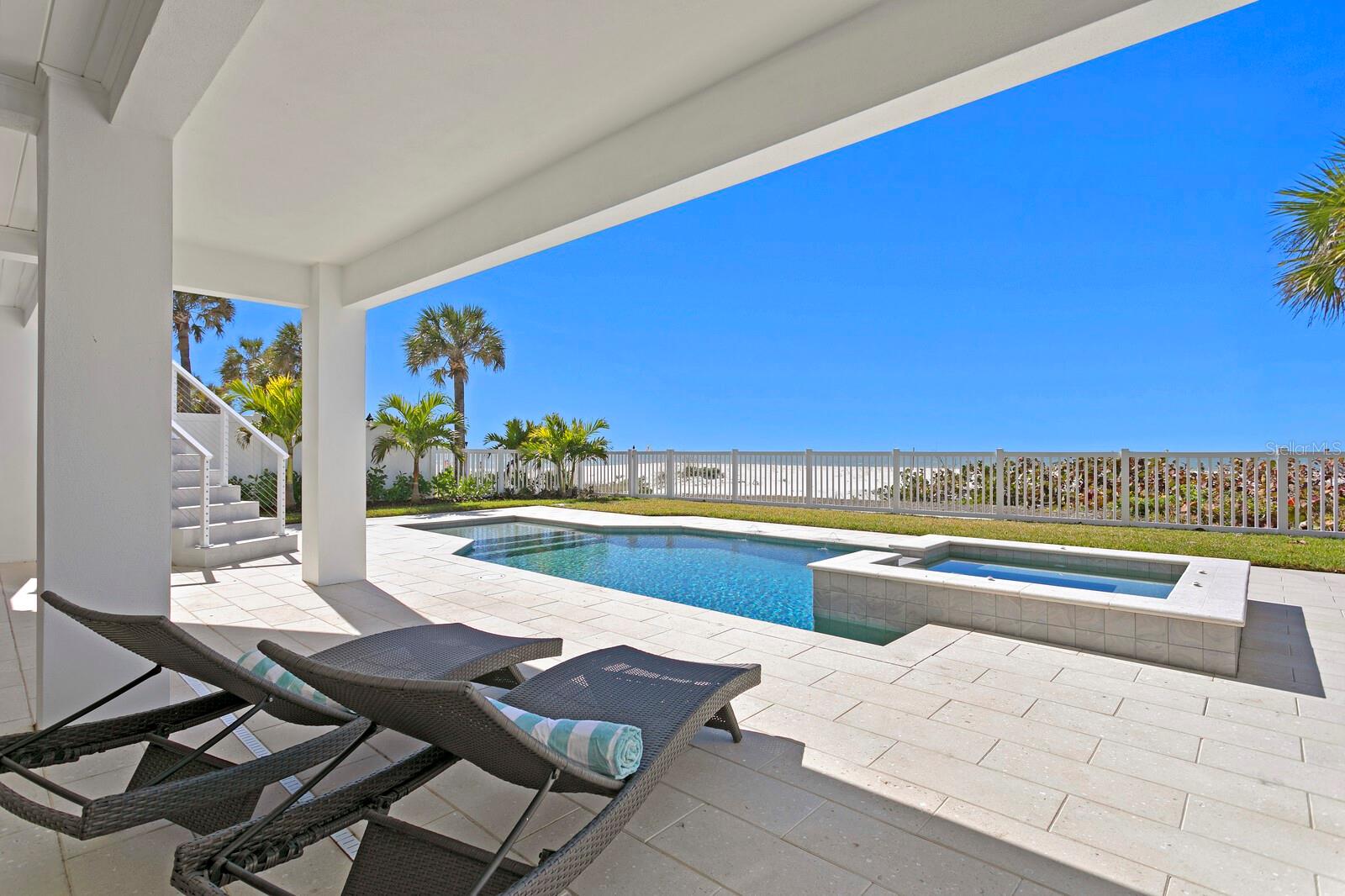 WELCOME TO THE ONLY BRAND NEW COMPLETED GULF FRONT HOME FOR SALE ON THE ENTIRE WEST CENTRAL COAST OF FLORIDA. GATED BEACHFRONT ESTATE WITH A RARELY FOUND PRIVATE DOCK ON THE INTRACOASTAL WATERWAY. Welcome home to the epitome of coastal luxury in this outstanding Indian Rocks Beach location boasting Modern Key West-inspired design by renowned Matta Architecture, a magnificent Gulf beach, and unobstructed panoramic views of the Gulf and Intracoastal. In addition to the dune-protected pristine beach, this unique family retreat features a new gated private dock with 20,000# boat lift on the beautiful Intracoastal Waterway. Built to the latest building codes with full exterior concrete block and steel reinforced foundation construction, impact windows/doors, and elevated FEMA-compliant living for flood risk reduction and optimal insurance premiums. Enjoy refined finishes and superior appointments throughout with over 9,551 Total Square Ft/ 5,825 SF Under Air which includes an oversized garage with parking for 6 cars and 3 stop Elevator. From the Mahogany front door to the custom contemporary cabinetry, the professionally designed interior takes full advantage of abundant natural light and outstanding water views from every room. An open floor plan offers an intimate entry, Great Room with LED cove ceiling lighting, 80-inch Modern Flames fireplace, expansive beachfront and intracoastal terraces and panoramic views. The refined kitchen is designed for seamless entertaining with top-of-the-line appliances, (Bertazzoni/Fisher & Paykel/Thermador) and custom finishes, a surround dining island and additional center island, luxurious Cachoeiro white marble countertops, 48-inch freestanding 6-burner gas range with griddle, dining area and an entertaining bar with prep sink, wine refrigeration, beverage center and ice maker. Living spaces include 5 ensuite bedrooms, a private office, flex room and laundry room on each living level. The top level Primary Retreat delivers on the best of privacy, appointments and views. Elegant accommodations include full retracting glass doors to full width private terrace and spectacular sunsets, adjacent sitting room with Gulf views, morning bar w/ sink, beverage center and terrace access, gracious his/hers closets and a stunning spa-inspired bath featuring dramatic finishes, Bianca Dolomite counters, a soaking tub and impressive dual shower. Immerse yourself in outstanding Florida coastal living outdoor oasis with a choice of entertaining areas, multiple terraces, expanded covered lanai, PebbleSheen saltwater pool and spa, Omni-Logic pool controller, LED lighting and Ivory Shellock pool deck where you can experience the sights and sounds of this unmatched beachfront location. Reinforced construction includes superior energy efficiency, smart home features, Hardie Plank siding, High Efficiency LG HVAC, premium Low-E impact windows/sliders, CAT6 wiring (cameras, WiFi and sound), natural gas, tankless water heater, whole house 22KW generator, oversized 6 car garage pre-wired for 2 EV charging stations, lush landscape and more. Note: This home is built to superior V zone standards and located in a more favorable AE flood zone, providing better safety and lower insurance premiums. Indian Rocks Beach offers a quiet, laid-back atmosphere with miles of sandy beach, yet remains convenient to the larger cities of Tampa, St Petersburg and Clearwater. Zoned to allow short term rentals if desired.