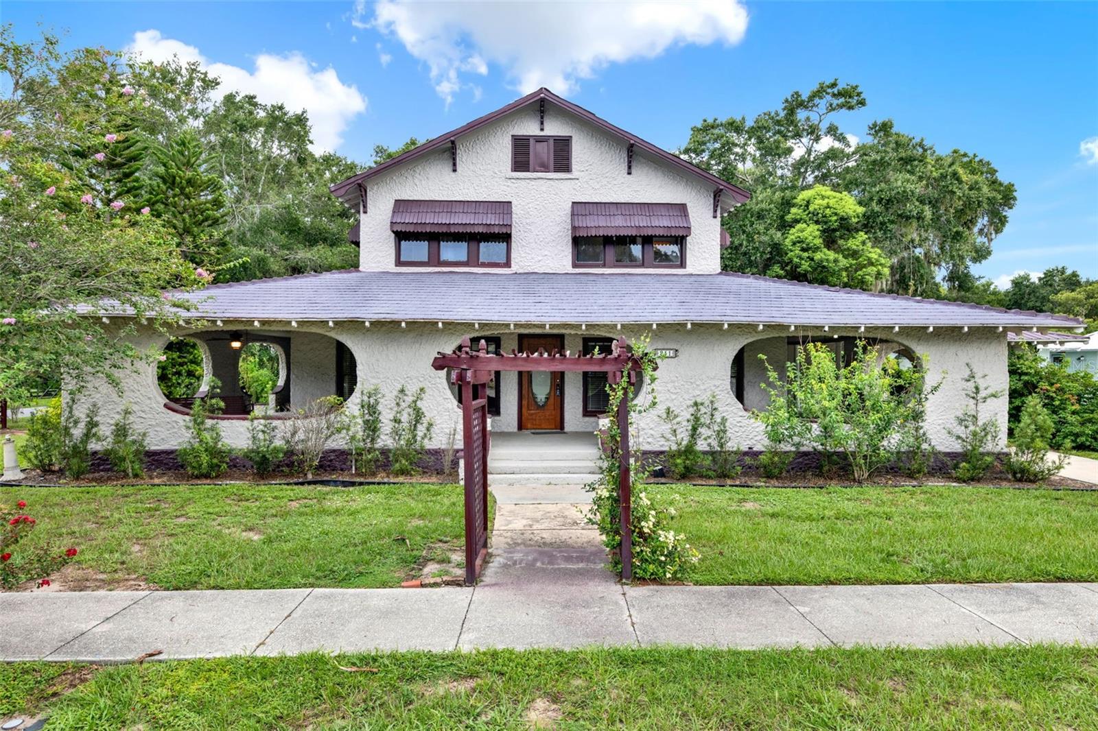 Fully Renovated 1920s Craftsman – 7BR/3.5BA – Move-In ReadyThis beautifully updated 1920s Craftsman home is the perfect retreat for a large family, offering 7 bedrooms, 3.5 bathrooms, and over 3,100 square feet of living space. Seamlessly blending historic charm with modern comfort, this move-in ready gem sits on a spacious corner lot in the heart of Umatilla.Interior Features: Expansive wraparound porch perfect for relaxing or entertaining
• Oversized, renovated kitchen with ceramic tile flooring
• Separate dining room and study/office
• Owner’s suite on the main floor with an adjacent bedroom – ideal for a nursery, guest room, or flex space
• Upstairs features 5 additional bedrooms and 2 full bathrooms
• Beautiful hardwood flooring throughout most of the home
• Exterior & Lot:
• Generous portico and large driveway for ample parking
• Plenty of space for RV or boat storage
• Two garden trellises welcome guests to a charming, landscaped front yard
• Mature towering trees offer shade and privacy
• Multiple flower beds and lush greenery enhance the curb appeal
• Location Highlights:
• Located less than half a mile from local schools and parks
• Close to numerous shopping and dining options
• Just a few miles from Lake Yale and Lake Eustis—part of Central Florida’s renowned Chain of Lakes
• Under an hour to the beach!
• Umatilla is a quiet, affordable community rich in history and natural beauty
Don’t miss your chance to own this spacious, character-filled home in a welcoming neighborhood. Schedule your private showing today!