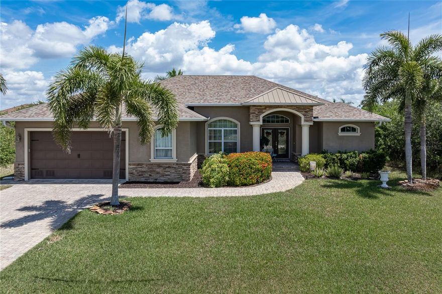 SAILBOAT ACCESS POOL HOME IN SOUTH GULF COVE W/50FT DOCK & 12,000 LB LIFT - Located in the growing, deed-restricted, waterfront community of South Gulf Cove, this 3 bed/2 bath + den home offers 87 feet of seawall, no bridges, and quick access to Charlotte Harbor in approximately 5–10 minutes. Inside, the home features a spacious, open layout anchored by the great room. The stylish foyer greets you with a shiplap accent wall and convenient coat closet as you enter the home. Great room boast 12ft ceilings that are accented by exposed beams and the built-in entertainment centers showcases a stone feature wall flanked by lighted display shelves. Wood-look porcelain plank flooring runs throughout the home, creating a clean, consistent look from room to room. The den/home office is tucked just off the great room - separated by French doors. At the heart of the home, the kitchen is designed for both function and flow, offering quartz counters, stainless steel appliances including a built-in convection oven and microwave. The large center island has breakfast bar seating. Upper glass-front cabinetry with lighting, a beverage center/coffee bar with bar fridge, and an oversized walk-in pantry provide ample storage. A built-in desk area just off the kitchen creates a convenient workspace without taking over the main living areas. Set just off the kitchen, the dining area is highlighted by a mitered bay window overlooking the pool and canal. Capture those gorgeous sunrises over the canal while enjoying your morning coffee. The split-bedroom design includes a generously sized master suite with two walk-in closets and a sitting area overlooking the pool and canal. The master bath offers split sinks, a linen closet, private WC and tiled walk-in shower. Guest rooms share a well-appointed guest bath with a combination tub/shower. One guest room features walk-out access to the lanai - give your guests a taste of Florida living here. Three sets of disappearing sliding glass doors open to the lanai extending the living space outside for true indoor/outdoor living. Multiple seating areas and sun decks surround the in-ground, heated, saltwater pool with attached spa, offering both covered and open-air options. A separate paver patio with fire pit sits along the water’s edge, creating an additional gathering space with a canal view. The backyard boasts 87ft of concrete seawall that features a 50-foot Trex dock equipped with a 12,000 lb canopied boat lift plus water and electric hook-ups dockside. The wide canal and quick, unobstructed route to open water make this property well-suited for serious boaters. Updates include a NEW roof, NEW pool screens, NEW hot water heater, NEW refrigerator, and a NEW canopy on the boat lift. Other amenities include hurricane protection, an attached oversized 2.5 car garage w/workshop area & lush tropical landscaping. South Gulf Cove offers an optional HOA - it's a great way to get to know your neighbors. South Gulf Cove continues to grow in popularity with its boating access, newer construction, and proximity to Gulf beaches, golf, and everyday conveniences. Make an appointment today and start enjoying life on the water.