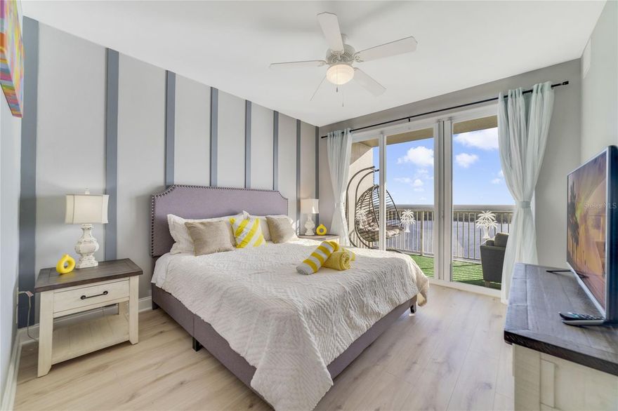 Seller Finance is available. Newly renovated unit on the 18th floor with beautiful water view.Enjoy resort-style waterfront living in this beautifully updated condominium offering stunning water views and a thoughtfully designed open layout. The home features a modern galley kitchen with granite countertops, stainless steel appliances, and updated cabinetry, seamlessly flowing into a bright living and dining area with wood-look flooring, crown molding, tray ceilings, recessed lighting, and contemporary fixtures. The sun-filled living room opens to a private covered balcony—perfect for relaxing or entertaining while enjoying expansive waterfront views.The spacious primary bedroom offers direct balcony access through sliding glass doors, abundant natural light, and a tranquil retreat. Two additional bedrooms provide flexible space for guests, a home office, or additional living needs. The well-appointed bathroom includes a double-sink granite vanity, modern fixtures, and a tub/shower combination. Community amenities include a waterfront pool, walking paths, and dock access, all set within a well-maintained waterfront environment conveniently located near shopping, dining, and major roadways. Two miles to the entrance of Disney World, 8mins drive to Disney Spring, near Universal Studio, Outlet ,Orange County Convention Center ect. Owner may self-manage the property through Airbnb or VRBO, or hire a property management company to generate passive income.