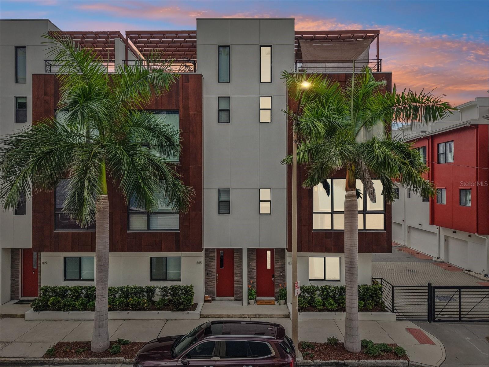 One or more photo(s) has been virtually staged. Modern. Vibrant. Downtown. Experience modern urban living in this stunning 3 bed, 3.5 bath townhouse with panoramic city skyline views from the rooftop deck and terrace. Tucked in the gated community of the Arlington?&?8th Townhomes, this four-story residence delivers a next-level lifestyle in Florida’s most dynamic and expanding city. Featuring spacious, open-concept living, and a private 2-car garage, this 2017 home offers the perfect blend of style, comfort, and convenience. Contemporary finishes throughout the home, floor-to-ceiling windows, chic lighting, quartz countertops, and lovely, durable, luxury vinyl plank flooring ensure easy living and easy maintenance. This home is equipped with Ethernet throughout, Spectrum Fiber 500/500, an on-demand tankless water heater, and resilient energy-efficient windows. The first floor offers a bedroom with en-suite full bathroom as well as entry to the garage that has an epoxy-finished floor. Up to the second floor, the spacious open concept living area is seamless between dining, kitchen and living area for entertaining and ease of everyday living. The kitchen is a dream featuring a large island, beverage station, contemporary premium wood cabinetry, stainless-steel appliances, and a natural gas range. The third level holds the key to your retreat with the fabulous primary bedroom, boasting high ceilings and featuring two walk-in closets leading into the primary bath with oversized shower and dual vanities. From here, you can go up to the breathtaking rooftop deck for the ultimate in relaxation while enjoying the city views. The rooftop is furnished with a natural gas hookup for a grill, and a wet bar with wine cooler built in. Located just minutes from downtown St. Pete’s top restaurants, galleries, and the waterfront and pier. There is plenty to enjoy within walking distance including the historic St Pete shuffleboard club, indoor rock climbing at Vertical Ventures, or taking a long bike ride or walk on the Pinellas Trail. This home places you in the center of it all while being a short drive to both Pass-a-Grille beach, the stunning white-sand Clearwater beach as well as St Pete/Clearwater airport and Tampa International Airport. Come live the elevated life and experience all that this vibrant city has to offer!