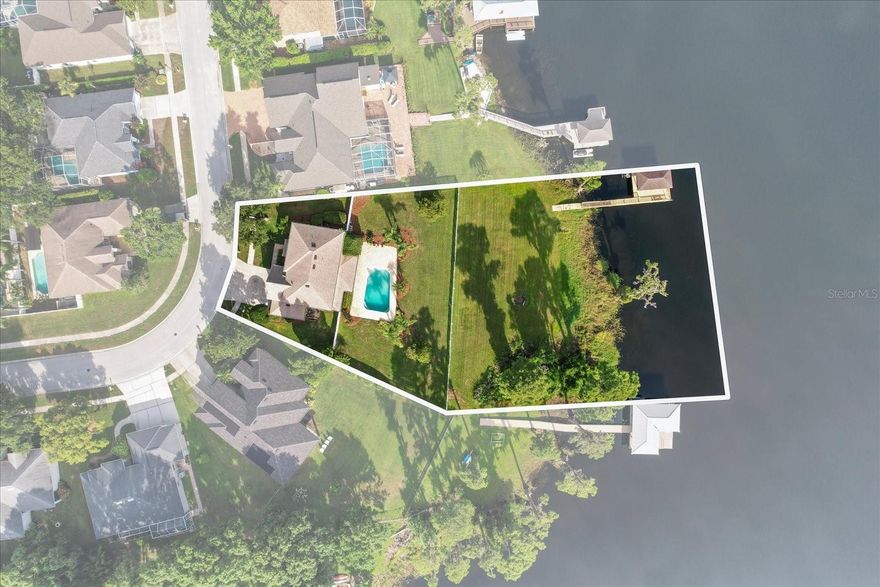 Set on a private 1.26-acre homesite with direct access to Lake Ann—a nearly 100-acre private, ski lake—this exceptional 5-bedroom, 3.5-bathroom estate offers the ultimate blend of luxury, comfort, and outdoors. Located in the desirable Wyndham Lakes community, this meticulously upgraded home features a private dock with boat lift & ski storage, resort-style pool, and an expansive outdoor entertaining area, creating the ideal Florida lakefront lifestyle.
With over 3,000 square feet of elegantly appointed living space, the home showcases timeless materials and no expenses spared in upgrades throughout. The 2021 chef’s kitchen is the heart of the home, featuring natural quartzite stone countertops, custom KraftMaid cabinetry with soft-close doors and built-in organization, paneled Sub-Zero and KitchenAid appliances, a Wolf induction cooktop, and double ovens. Thoughtful details like recessed LED lighting, smart dimmers, and integrated multi-zone ceiling speakers enhance both functionality and ambiance all while overlooking your waterfront lot on Lake Ann.
The open-concept family room is wired for immersive 7.1 surround sound and pre-wired for a wall-mounted TV with concealed cabling. Formal living and dining spaces also offer recessed audio, while the dedicated office includes custom cabinetry, wall-mounted monitors, and a 5.1 surround sound system.
Upstairs, new plush carpeting complements the rich French Oak engineered hardwood floors found throughout the main level. The luxurious primary suite features a spa-like bathroom updated in 2022 with quartz countertops, high-end Delta fixtures, and ceiling-integrated audio. All bathrooms have been upgraded with premium finishes, including American Standard Chair Height Elongated Toilets.
Additional enhancements include a fully wired whole-home WiFi system, a smart Alarm.com security system with remote access, IP camera system, a 2023 high-capacity 50-gallon water heater, 2021 water softener, and a MyQ Chamberlain smart garage door opener. The home is climate controlled by dual Trane variable-speed HVAC systems with smart thermostats, and protected by PGT double-pane, Category 5 hurricane-impact windows and doors. A new roof was installed in 2022 for added peace of mind.
Step outside to an entertainer’s dream. The expansive covered lanai includes a built-in Weber Summit gas grill, granite countertops, an outdoor refrigerator, and a Samsung 50" outdoor TV. Surrounding the pool and backyard are multi-zone ceiling and landscape speakers, complete with a subwoofer for immersive outdoor sound. The ultra-quiet Hayward pool pump ensures peaceful enjoyment of your private oasis. The oversized pool features beautiful pavers with a fully fenced in yard for added privacy. leading to your own private dock and boat lift on the beautiful Lake Ann. Featuring a 10,000lb boat lift and 2 manual PWC lifts for your jet skis.
1300 Wyndham Lakes Drive is a rare opportunity to own a truly turn-key, fully upgraded lakefront estate in one of Odessa’s most sought-after communities on a massive 1.26 acre private lot. This property offers a lifestyle without compromise.
3D tour, video walkthroughs and home dimensions are available. Schedule a private tour of this extraordinary lakefront retreat.