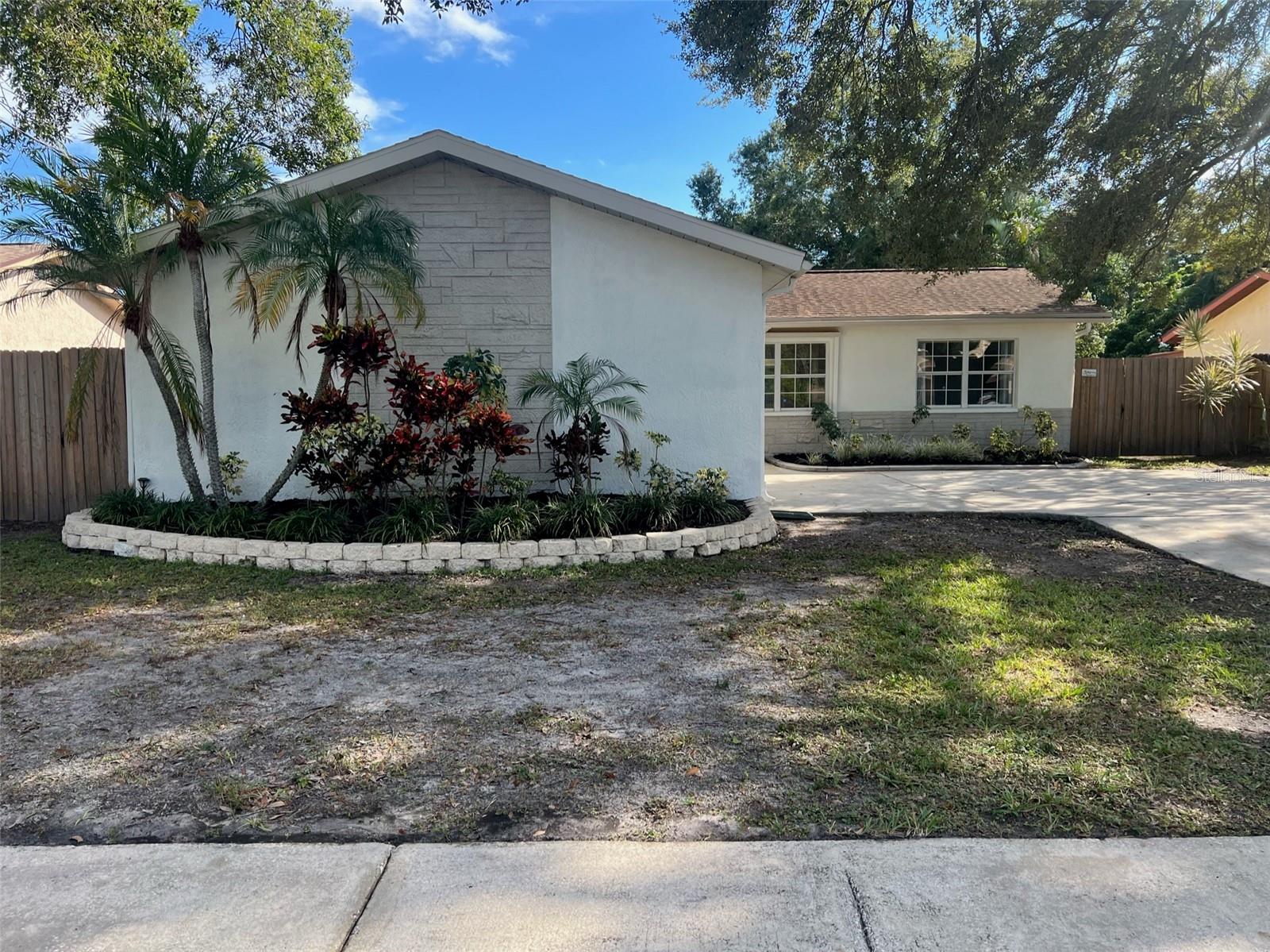 Absolutely beautiful 2/2/2 totally remodeled home in family neighborhood on the water. All new luxury vinyl plank flooring throughout. Ceiling fans in every room. Open floor plan with beautiful kitchen with huge island, all new lighting, quartz countertops, 42" shaker cabinets, stainless appliances, built in microwave, pantry. 2 nice size bedrooms with walk in closet in master. Beautifully updated bathrooms with new vanities. Large screened room overlooking water. Oversized garage. SOLAR PANELS which means NO electric bill!!! THIS ONE WON'T LAST!!