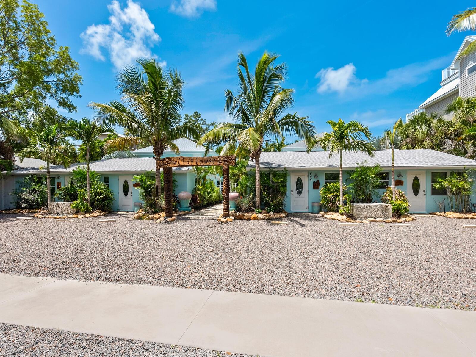 SIESTA KEY INVESTMENT PROPERTY. Great location! Welcome to the Wildflower. Just steps from the #1 Beach in USA. Nestled within a tropical oasis, this charming 8 plex 4 ground level units and 4 second level units, with 8 parking spaces offers a unique blend of comfort and natural beauty. Surrounded by vibrant tropical flora, enter the common area courtyard centered around a sparkling heated pool, perfect for relaxing after a day at the beach. The courtyard backdrop includes a standing waterfall that offers the tranquil sounds of nature. A very unique detail to any outdoor living space. Adjacent from the pool are two screened communal areas. A game room, with tv, ping pong table, pool table, arcade & washer/dryers and restroom with shower. The second lanai has a sectional sitting area with tv, fire pit and sauna. Plenty of beach and pool accessories, noodles, rafts, beach chairs, carts, etc,. for guests to enjoy. There is also a dock, across the street that is included with the sale of the property. Ideal for kayak launching or fishing. The canal leads to the Siesta Key Grand Canal. The interiors are adorned with NEW modern finishes, appliances, and furnishings. Interior spaces can be combined by interior door. Each room has been eloquently decorated with a coastal theme. Guests can take leisurely strolls to Siesta Key Village to the shops, restaurants and entertainment. The free trolley stop is also around the corner. This turnkey property is in like NEW CONDITION and is the perfect investment opportunity. Schedule your showing to see this amazing slice of paradise.