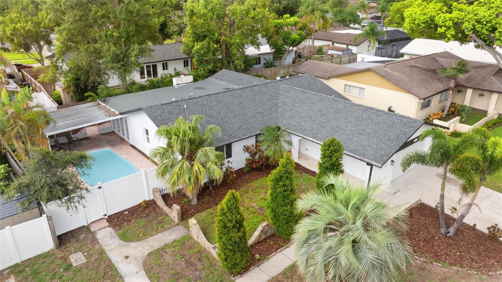 Located in the highly desirable neighborhood of Seminole Grove, on a quiet street just blocks from the Pinellas Bike Trail, this
stunning 3-bedroom, 2-bath home with a 2 car garage offers nearly 2,000 square feet of comfortable, family-friendly living space
that has been thoughtfully updated! The landscaped backyard features a large private pool and patio—ideal for relaxing or hosting
guests year-round—and flows seamlessly into the living space, where vaulted ceilings and a light-filled open layout create an
inviting atmosphere. Unique details like white oak hardwood floors and a beautiful stone fireplace in the bonus room add warmth and
character throughout. The kitchen is equipped with Taj Mahal quartzite countertops, brand new Whirlpool stainless steel appliances,
and an oversized walk-in pantry and laundry room for added functionality. With a stylish yet practical floor plan and thoughtful updates throughout, this home is truly move-in ready. Located just minutes from
top-rated schools, parks, shopping, and the beach, it offers the perfect combination of location, lifestyle, and peace of mind.