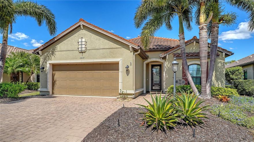 Experience refined living in this lightly lived-in and impeccably maintained three-bedroom, three-bath residence, ideally in sought-after Esplanade Golf & Country Club. Offered well below its 2023 purchase price, this home presents an exceptional opportunity and outstanding value. Designed with comfort, security and peace of mind, it stands apart with Category 5 hurricane-rated windows, a whole-house generator connected to natural gas, a front storm door, roll-down hurricane shutters, a drainage improvement system, water treatment and enhanced smoke detection. Every detail reflects meticulous care and pride of ownership. The thoughtfully designed Lazio floor plan strikes a balance between everyday ease and effortless entertaining, blending open gathering spaces with private retreats. The chef-inspired kitchen boasts a spacious gleaming island, deep-volume cabinetry with pull-out drawers, a bright window over the sink, three designer pendant lights and a walk-in corner pantry, ideal for hosting guests or enjoying casual family meals. The primary suite serves as a serene retreat, featuring a custom-built walk-in closet complete with drawers, jewelry storage and a secure floor-mounted safe. Two additional bedrooms, each with their own private bath, plus a versatile den or office, offer comfort and flexibility for any lifestyle. Additional features include recessed lighting throughout, a newer HVAC system and a mini-split air-conditioning unit for personalized climate control in the primary suite. Go outside to the extended, covered and screened lanai, an inviting outdoor living space designed for year-round enjoyment. Relax at the granite summer kitchen bar, unwind in the hot tub, or take in the lush, landscaped garden wall offering beauty and privacy. Motorized storm and privacy shades provide an extra layer of comfort and security. Discover the pinnacle of resort-style living at Esplanade in Lakewood Ranch, where every day feels like a getaway. This vibrant, amenity-rich community features beautifully landscaped grounds, scenic recreational trails and a world-class array of activities. Residents enjoy access to a championship golf course, full-service spa, tennis and pickleball courts, and an elegant clubhouse offering fine dining and social events. Whether lounging by the resort pool or gathering with friends for a sunset cocktail, Esplanade offers a blend of luxury, leisure and connection in the heart of Lakewood Ranch.