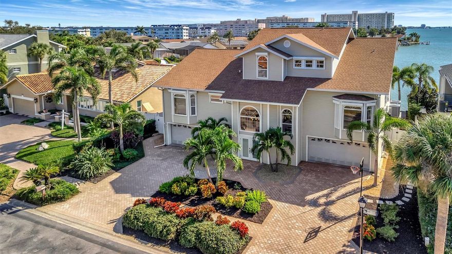 Welcome to a true waterfront paradise offering spectacular, unobstructed open bay views—the ideal setting for the Florida lifestyle, perfect for kayaking, swimming, and quiet enjoyment. Discover unparalleled luxury in this exquisite, fully renovated waterfront estate nestled within a spectacular GATED COMMUNITY. Enjoy the beautiful amenities of the renowned Pasadena Yacht & Country Club, all while benefiting from an incredible location with less than a 15-minute commute to vibrant Downtown St. Pete! This estate has been renovated top-to-bottom and offers 5 spacious en-suite bedrooms plus a 1/2 bathroom, providing comfort and privacy for all. The exterior boasts an entertainer’s dream with an extended deck overlooking the bay, a resurfaced pool, and a brand new, unused pool bar area. This ultimate outdoor kitchen features two new refrigerators, a dedicated ice maker, dishwasher, and a 3-tap system for premixed beverages. The waterfront is ready for your toys with a new dock system featuring a confirmed 16,000 lb fully loaded boat lift and a separate lift for two jet skis. Anglers will appreciate the brand new installed fish cleaning station with a dedicated water line. Inside, the home is appointed with the highest level of luxury finishes. The flooring is brand new throughout, featuring elegant new carpet and premium luxury vinyl plank (LVP). The living room offers a grand scale with high ceilings, complemented by tasteful Hunter fans and high-end Moen fixtures in the baths. Every bathroom features the exquisite Cambria Brittanica Quartz from the Luxury Collection. The gourmet kitchen is equipped with top-of-the-line KitchenAid appliances (including a new dishwasher), and the laundry room features the largest capacity Samsung washer and dryer set available. Practical amenities abound, including a 4-car garage that is convertible to 5-car capacity for the collector or enthusiast. Crucially, the home features a dedicated craft room—completely separate from the bedrooms and den—offering an invaluable space for hobbies without sacrificing a bedroom. The primary suite is a true retreat, featuring a large walk-in closet and a convenient wet bar area with a fridge and sink. This is not just a house; it's a completely renovated, ready-to-enjoy luxury compound.