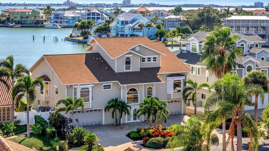 Welcome to a true waterfront paradise offering spectacular, unobstructed open bay views—the ideal setting for the Florida lifestyle, perfect for kayaking, swimming, and quiet enjoyment. Discover unparalleled luxury in this exquisite, fully renovated waterfront estate nestled within a spectacular GATED COMMUNITY. Enjoy the beautiful amenities of the renowned Pasadena Yacht & Country Club, all while benefiting from an incredible location with less than a 15-minute commute to vibrant Downtown St. Pete! This estate has been renovated top-to-bottom and offers 5 spacious en-suite bedrooms plus a 1/2 bathroom, providing comfort and privacy for all. The exterior boasts an entertainer’s dream with an extended deck overlooking the bay, a resurfaced pool, and a brand new, unused pool bar area. This ultimate outdoor kitchen features two new refrigerators, a dedicated ice maker, dishwasher, and a 3-tap system for premixed beverages. The waterfront is ready for your toys with a new dock system featuring a confirmed 16,000 lb fully loaded boat lift and a separate lift for two jet skis. Anglers will appreciate the brand new installed fish cleaning station with a dedicated water line. Inside, the home is appointed with the highest level of luxury finishes. The flooring is brand new throughout, featuring elegant new carpet and premium luxury vinyl plank (LVP). The living room offers a grand scale with high ceilings, complemented by tasteful Hunter fans and high-end Moen fixtures in the baths. Every bathroom features the exquisite Cambria Brittanica Quartz from the Luxury Collection. The gourmet kitchen is equipped with top-of-the-line KitchenAid appliances (including a new dishwasher), and the laundry room features the largest capacity Samsung washer and dryer set available. Practical amenities abound, including a 4-car garage that is convertible to 5-car capacity for the collector or enthusiast. Crucially, the home features a dedicated craft room—completely separate from the bedrooms and den—offering an invaluable space for hobbies without sacrificing a bedroom. The primary suite is a true retreat, featuring a large walk-in closet and a convenient wet bar area with a fridge and sink. This is not just a house; it's a completely renovated, ready-to-enjoy luxury compound.