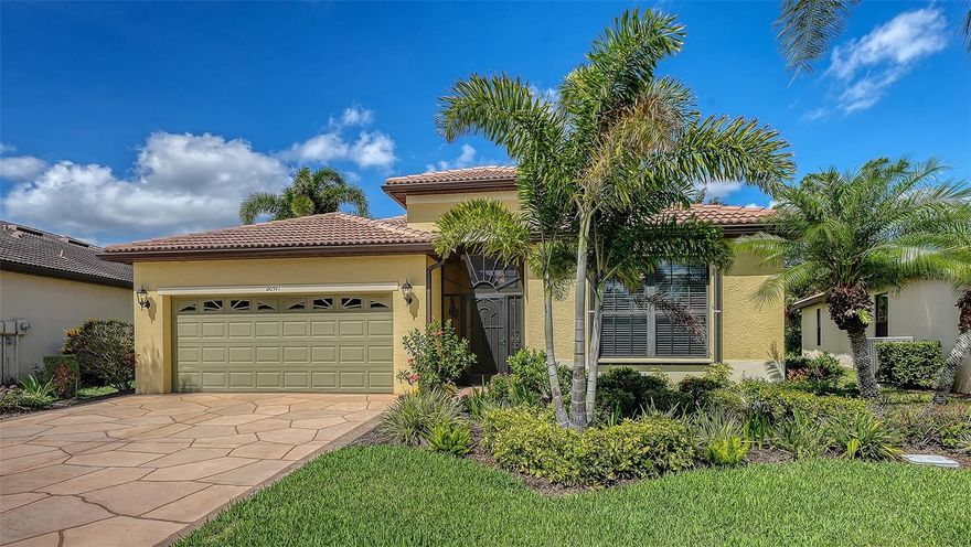 This beautifully maintained Milan model features 2 bedrooms plus a den and an open-concept floor plan with spacious living, dining, and family rooms designed for comfortable everyday living and entertaining. Step outside to a stunning outdoor retreat with a sparkling saltwater pool, spill-over fountain, and lush tropical landscaping that creates a private, resort-like setting. Located in Venetian Falls, Venice’s premier gated 55+ community, this home offers resort-style living just minutes from Gulf beaches, shopping, dining, and the charming historic district. A screened front entry welcomes you into an inviting foyer accented by a leaded-glass front door insert with sidelight and transom windows.
The well-appointed kitchen features granite countertops, solid wood cabinetry with decorative trim, stainless steel appliances, and a walk-in pantry. The adjoining bay-style dining area offers great views! The screened lanai provides the perfect space for outdoor dining, grilling, or simply relaxing in the sun or shade. Additional highlights include easy-to-operate accordion storm shutters, fresh interior paint, new bedroom carpeting, and a two-car garage with epoxy-coated flooring and a utility sink. Exceptional curb appeal is enhanced by stamped concrete on the driveway, walkway, and lanai and beautiful landscaping all-around. Venetian Falls residents enjoy outstanding amenities including a clubhouse with a heated lap pool and spa, resistance-walking pool, fitness center, billiards room, bocce courts, full-time activities director, on-site management, and more. The reasonable HOA fee also includes lawn maintenance, irrigation, basic cable, and internet. Don’t miss this move-in-ready home with a private pool in one of Venice’s most sought-after communities!