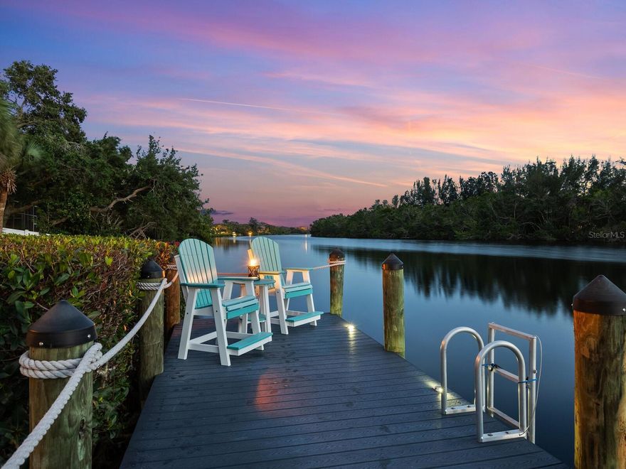 Eight years young and beautifully updated to rival new construction, this fabulous, gated waterfront Siesta Key estate offers abundant space with 4 bedrooms, 5 full baths, den, and family room with unobstructed views of the peaceful estuary, Heron Lagoon. The covered entry leads to a foyer with a three-stop elevator and stairs to the main living level, an open-concept floor plan with views of the waterfront from every room. You’ll enjoy entertaining friends and family in this well-designed, open space. The living and dining areas flow easily into the well-equipped kitchen, which will please the most discerning chef. Featuring quartz countertops, an oversized island with breakfast bar seating, pendant lighting, gorgeous wood cabinetry, natural gas cooktop, stainless steel appliances, full pantry, and planning desk. Through a wall of glass sliders step out to the large, screened, west-facing balcony, the perfect place for al fresco dining at sunset while savoring colorful Siesta Key sunsets. The spiral staircase from the balcony allows easy access to the pool, yard and dock area. Additional rooms on this level – an office with French doors and balcony, an en-suite guest bedroom, full bath, and large laundry room. Upstairs, the centrally located family room overlooks the waterway with a second large balcony. The spacious owner’s suite will be your private retreat with large windows overlooking the spectacular waterfront vista (with peek-a-boo gulf views) and features a luxurious bathroom with dual vanities, soaking tub, shower, and abundant walk-in closet. Two en-suite guest bedrooms complete this level. Outside, a covered poolside bar and grilling area with a motorized poolside awning provides plenty of daytime shade. Tropically landscaped, the spacious yard features a sparkling pool and spa with paver decking and plenty of room for kids and pets to play. Fish from your dock or launch a kayak, canoe, or paddleboard in the serene tidal waters of the lagoon; only non-motorized vessels are permitted, protecting the natural environment, and enhancing your quiet enjoyment of the beautiful, natural surroundings. You’ll never tire of the nightly show of blazing island sunsets with spectacular mango and cotton candy skies. Additional features of this fabulous home include tile and engineered hardware floors throughout, motorized privacy blinds on outdoor patios, abundant storage, kayak launch, Trek decking on dock, an oversized three-car garage, paver driveway and walkways, additional parking and security gate. Store your powerboat at nearby Turtle Beach Marina, close to South Siesta’s Turtle Beach and the world-famous white-quartz sands of Siesta Beach and Siesta Village. Mainland Sarasota’s shopping, dining, cultural and urban amenities are a short drive over the Stickney Point bridge.