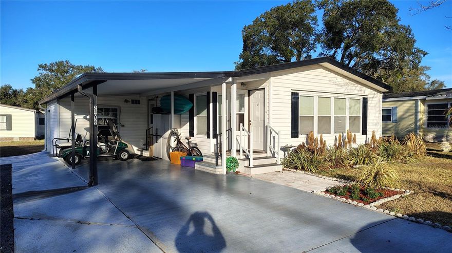 Welcome to this two bedroom two bath home located in the highly sought after 55 plus community of Plantation at Leesburg. A new roof was installed 6 years ago plus luxury vinyl plank flooring throughout most of the home, separate living and family room areas, dining room, kitchen with stainless appliances and tiled counter tops, inside laundry with cabinets, full guest bath, large guest bedroom with 8 ft closet with mirror and doors, master bedroom with dual closets, renovated primary bathroom with dual sinks and dual medicine cabinets, newer shower and light fixtures and upgraded fans throughout the home. There's a Florida room and a nice size wood deck for barbecuing an outside entertaining. They're good size shed combination workshop with golf cart garage door and covered carport. This golf course community has 2 golf courses, 24 hr. guards at the entrances, three club houses, three swimming pools, large Manor clubhouse which hosts plays and musical events as well as many other activities. Activities include billiards, exercise facilities, bocce ball, tennis, pickleball, baseball field, batting cage, archery, RV and boat storage as well as many others.