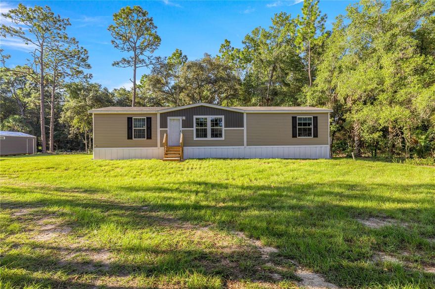 Discover this brand-new, 3-bedroom, 2-bath mobile home nestled on over an acre in Crystal River, situated at the end of the Cul-de-sac. Designed with an open floor plan, the home boasts drywall interior walls with a tape-and-texture finish, creating a modern and inviting atmosphere. The kitchen is a centerpiece, featuring stainless steel appliances, including a built-in microwave, range, glass range hood, and dishwasher. A spacious island offers ample room for meal preparation and casual dining, while the adjacent dining area includes sliding doors that lead to a deck—perfect for enjoying the scenic outdoors. The master suite is thoughtfully designed with a dual-sink bathroom, ensuring plenty of space and convenience. The additional two bedrooms provide flexibility for guests, family, or a home office. With its seamless flow, the layout makes the home feel bright, open, and airy. Located in the charming town of Crystal River, this property offers proximity to the Gulf of Mexico and stunning natural springs, making it ideal for boating, fishing, and outdoor enthusiasts. While embracing a serene small-town vibe, the home is conveniently close to shopping, dining, and modern amenities. Make this beautiful property your retreat and enjoy all that Crystal River has to offer!