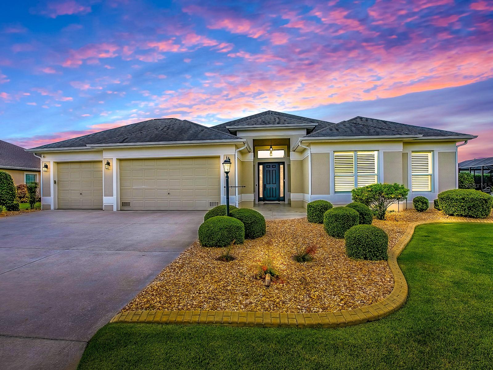 BOND PAID! STUNNING PREIMIER HOME! PROFESSIONALLY LANDSCAPED LOT W/ ROOM FOR A POOL! PREMIER LOCATION - The Village of Fernandina at MacClenny! This AVALON Floor Plan Features 4 bedrooms, 3 bathrooms, and a 3-Car Garage with Epoxy Floors. Enter through the front door and take in the light-filled, open-concept layout with sightlines that extend all the way to the Beautiful FLORIDA ROOM! Impressive Soaring Ceilings and Doorways, Tile Flooring and Crown Molding (in the main living area). The OPEN FLOOR PLAN seamlessly blends the Gourmet Kitchen, complete with upgraded Stainless Steel Appliances, Quartz Counters, Island & Large Breakfast Bar, with the Sunny Living and Dining Areas. What you will like BEST is the GRAND, 'LIGHT & BRIGHT' FLORIDA ROOM adding Amazing Living Space to this Beautiful Home!! The Primary Suite showcases a walk-in closet, EnSuite Bath with Double Sinks and a Roman Shower. The Secondary Bedroom also showcases a Walk-in Closet, EnSuite Bath with a Walk-in Shower. The Third and Fourth Guest Bedrooms are good-sized with built-in closets and are adjacent to the Third Guest Bath with tub/tiled shower combo. The Large Laundry Room is privately located between the Kitchen and Garage and has plenty of Storage Cabinets, Quartz Counters, a Utility Sink and Window.
The three car garage with epoxy floors has plenty of space for your vehicles, golf carts, & toys! The Village of Fernandina at MacClenny is an oasis of Premier homes, surrounded by the beauty of the Bonifay Country Club golf course. Neighbors enjoy each other's company in this active community along with the ample golf, recreation and dining opportunities. The location offers easy access to the Colony and Pinellas shopping areas. Lake Sumter Landing lies to the north, and Brownwood Paddock Square is a short ride to the south.